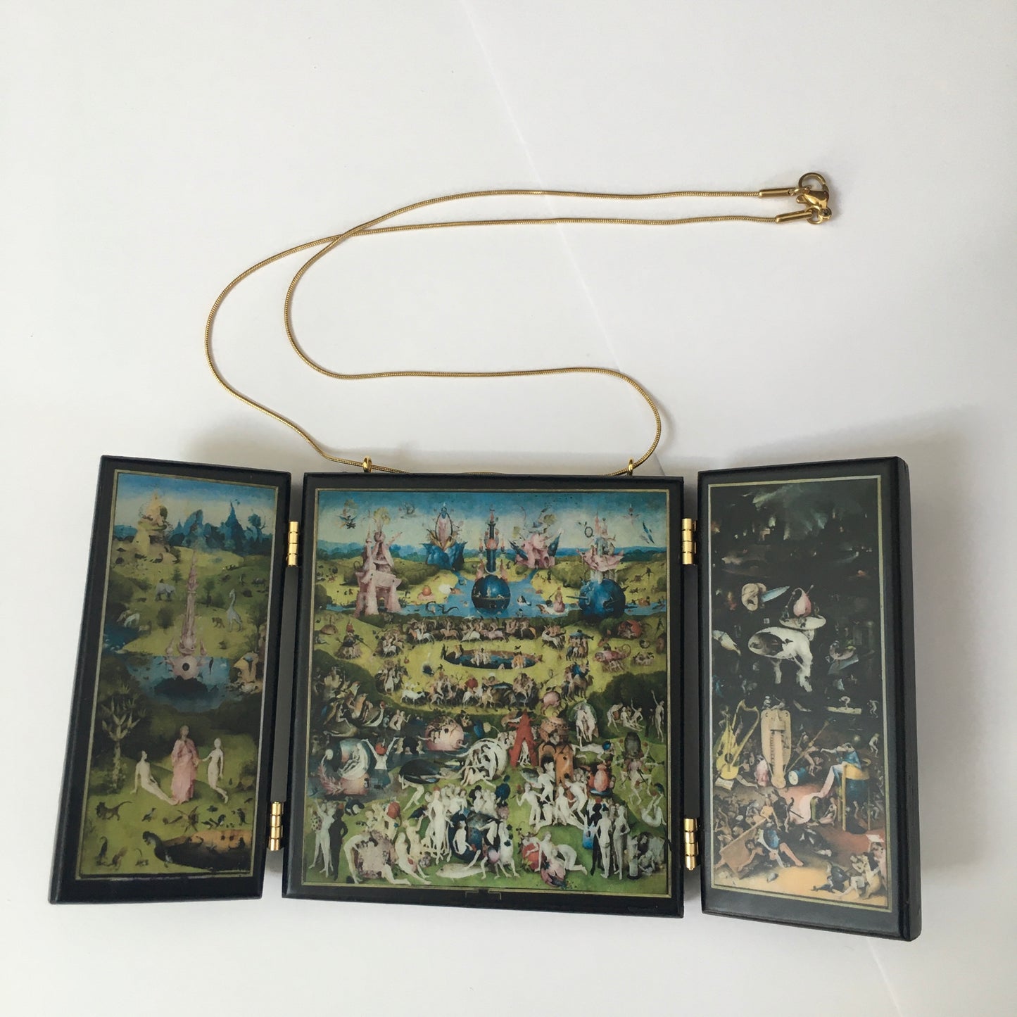 A fully functioning, reproduction in miniature of the three panelled masterpiece, Garden of Earthly Delights by Hieronymus Bosch, turned into a beguiling necklace.