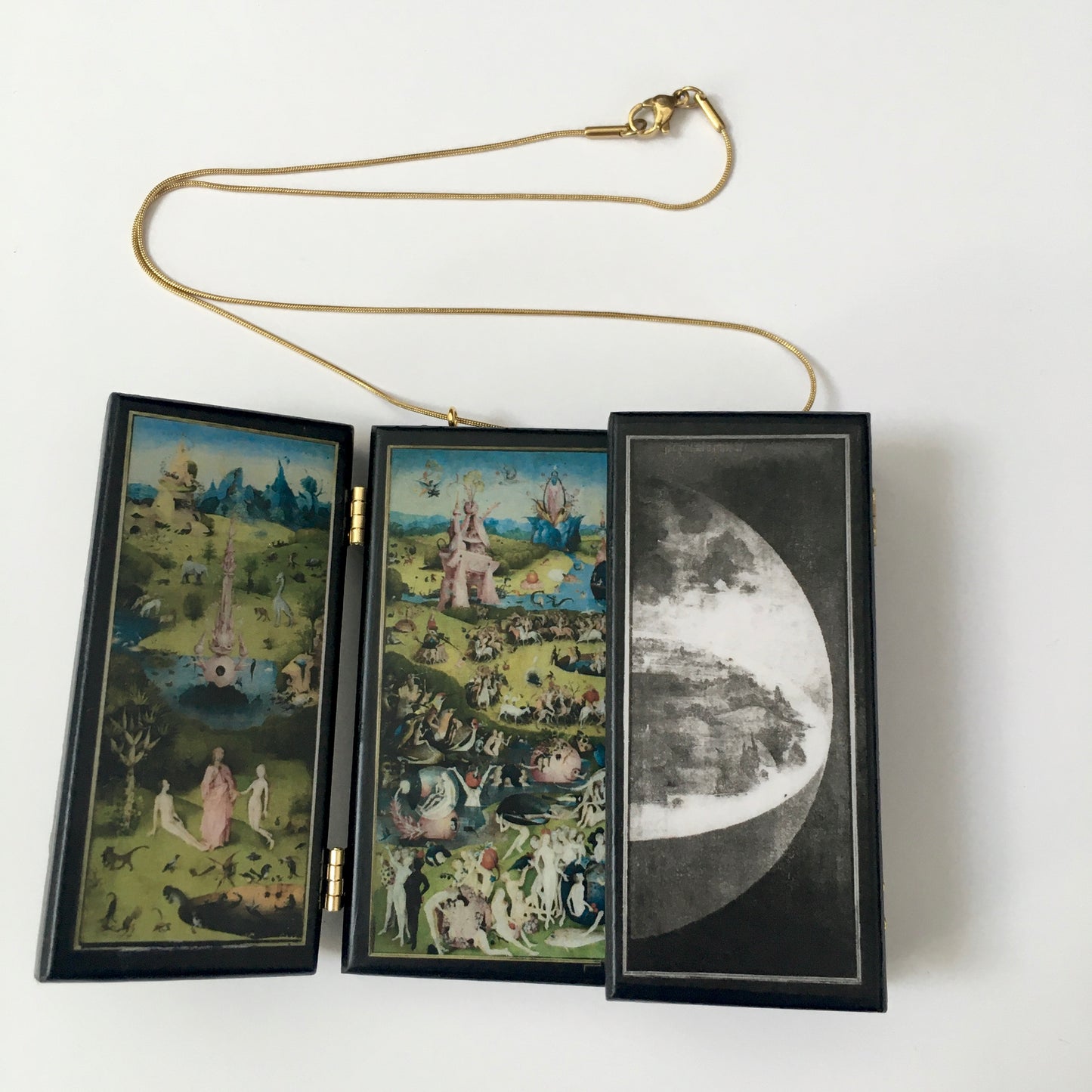 A fully functioning, reproduction in miniature of the three panelled masterpiece, Garden of Earthly Delights by Hieronymus Bosch, turned into a beguiling necklace.