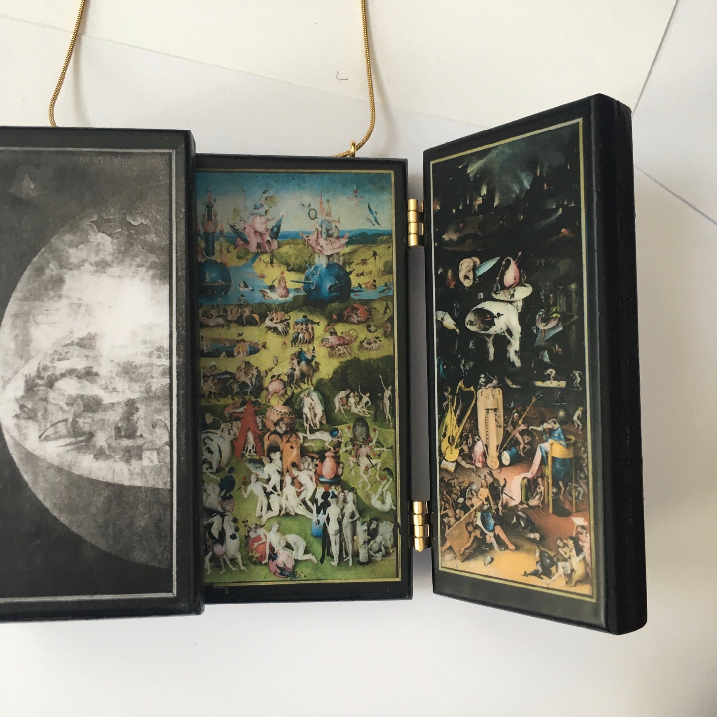 A fully functioning, reproduction in miniature of the three panelled masterpiece, Garden of Earthly Delights by Hieronymus Bosch, turned into a beguiling necklace.