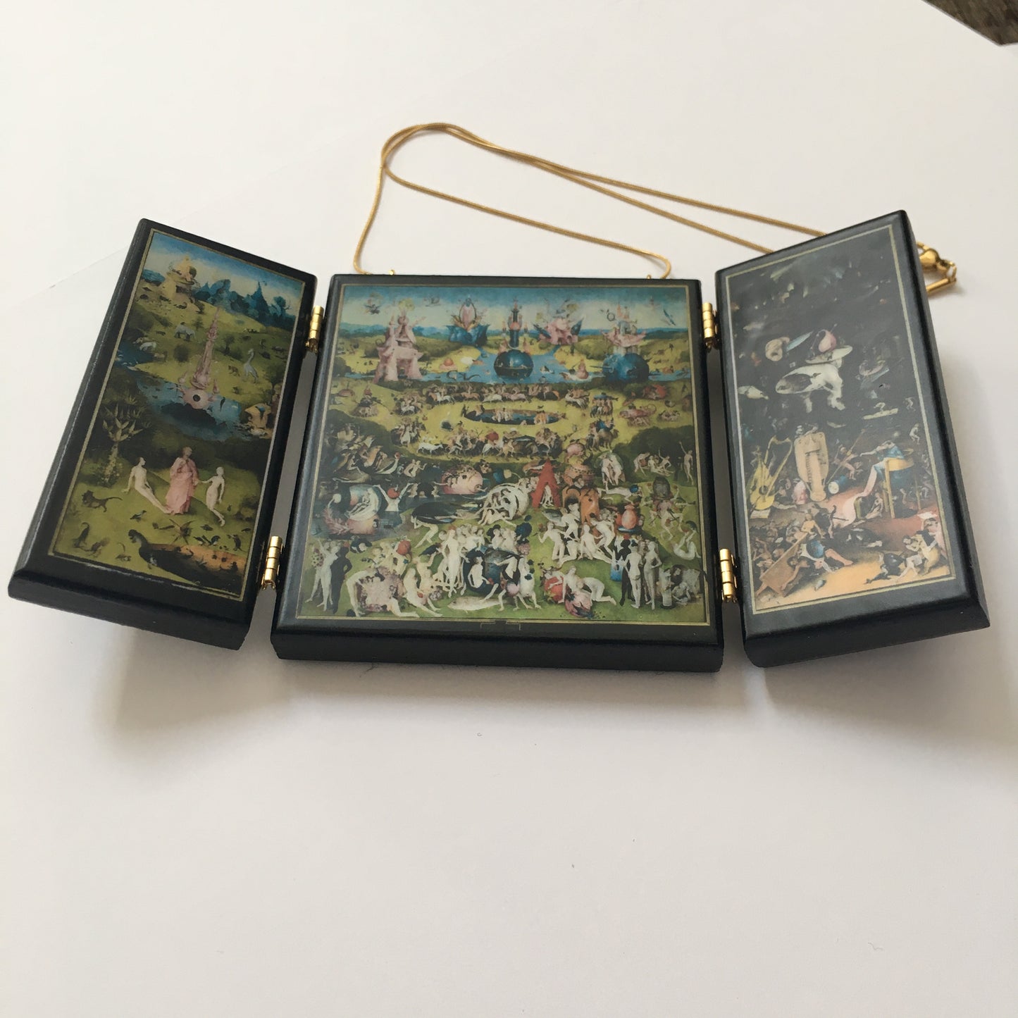 A fully functioning, reproduction in miniature of the three panelled masterpiece, Garden of Earthly Delights by Hieronymus Bosch, turned into a beguiling necklace.