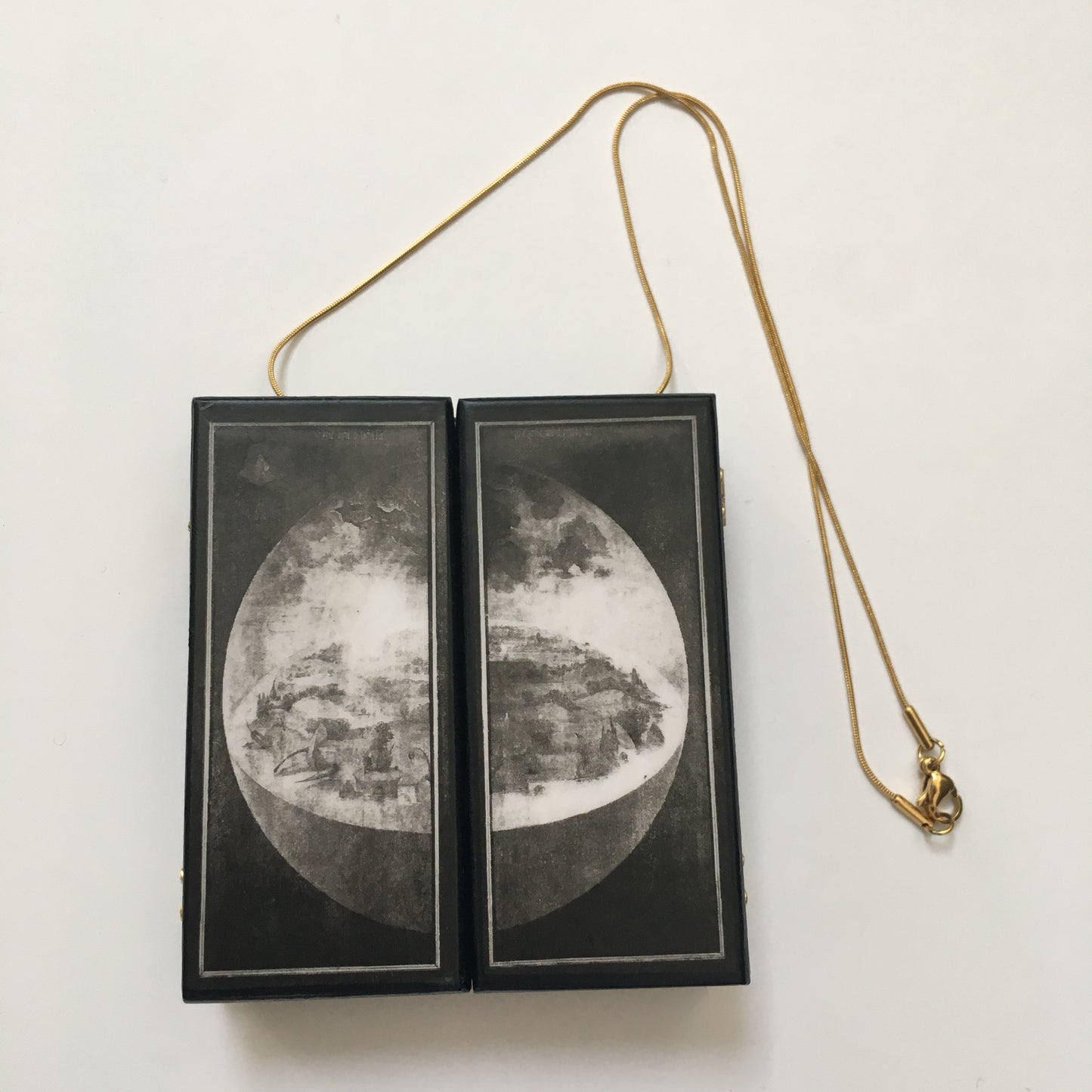 A fully functioning, reproduction in miniature of the three panelled masterpiece, Garden of Earthly Delights by Hieronymus Bosch, turned into a beguiling necklace.