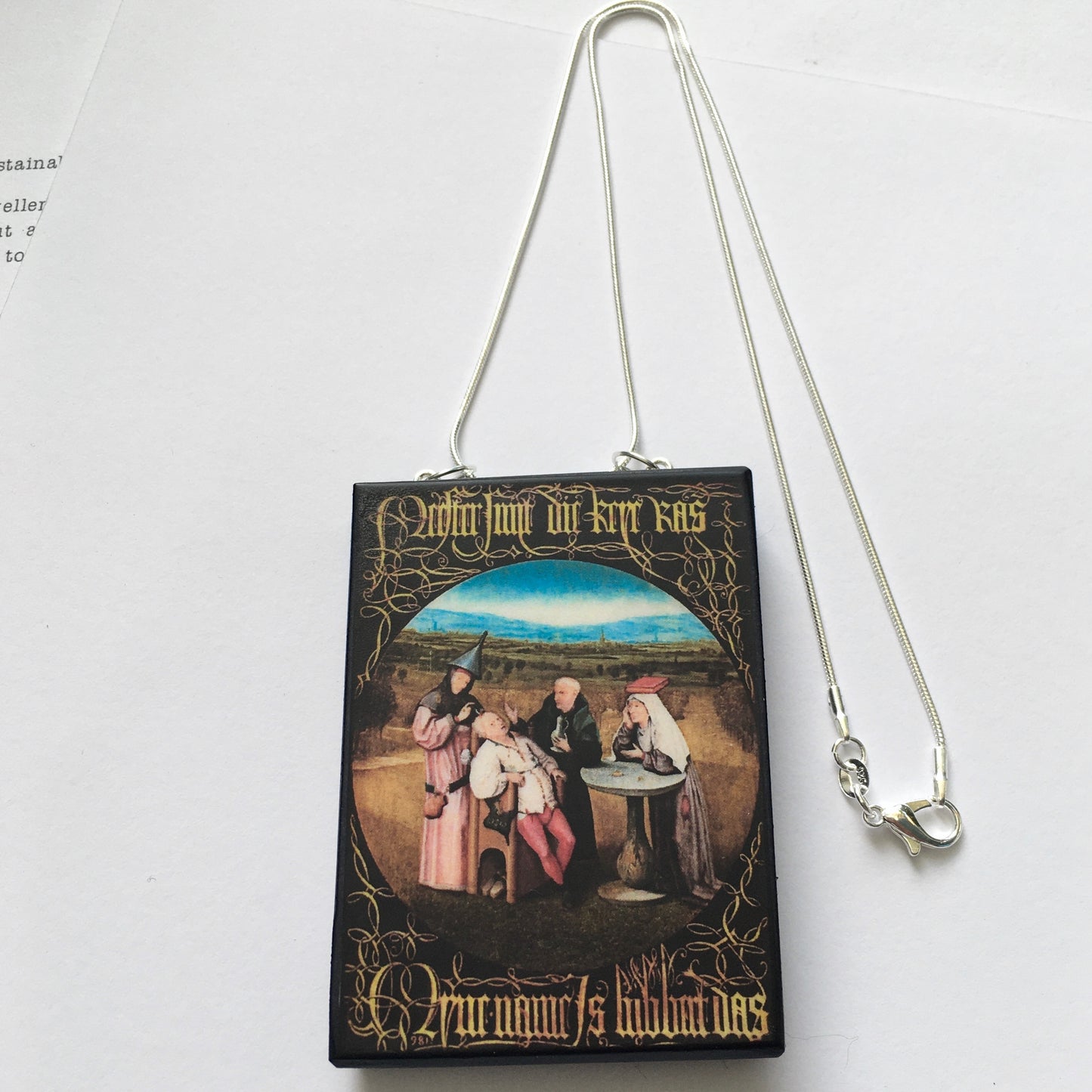 Hieronymus Bosch painting Cutting the Stone on top of this sustainable wood pendant with 925 sterling silver snake chain.