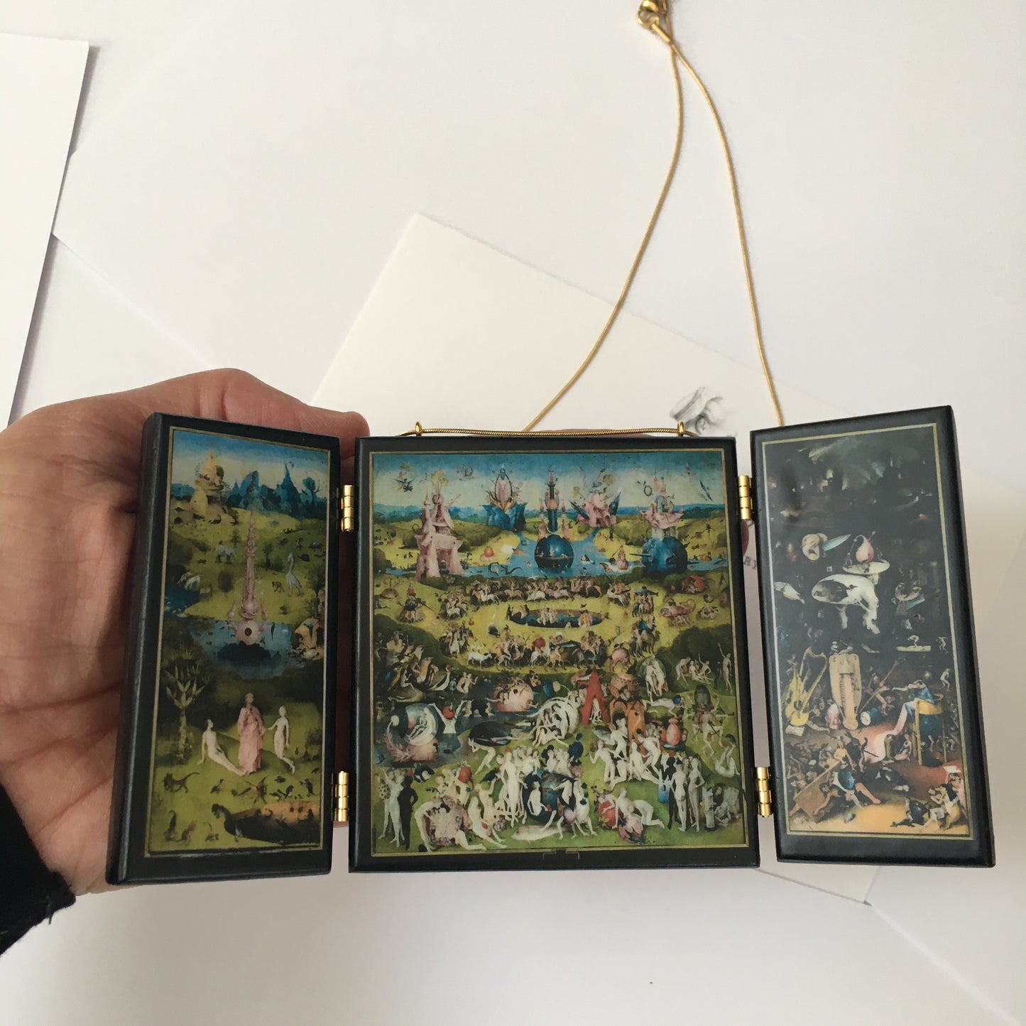 A fully functioning, reproduction in miniature of the three panelled masterpiece, Garden of Earthly Delights by Hieronymus Bosch, turned into a beguiling necklace.