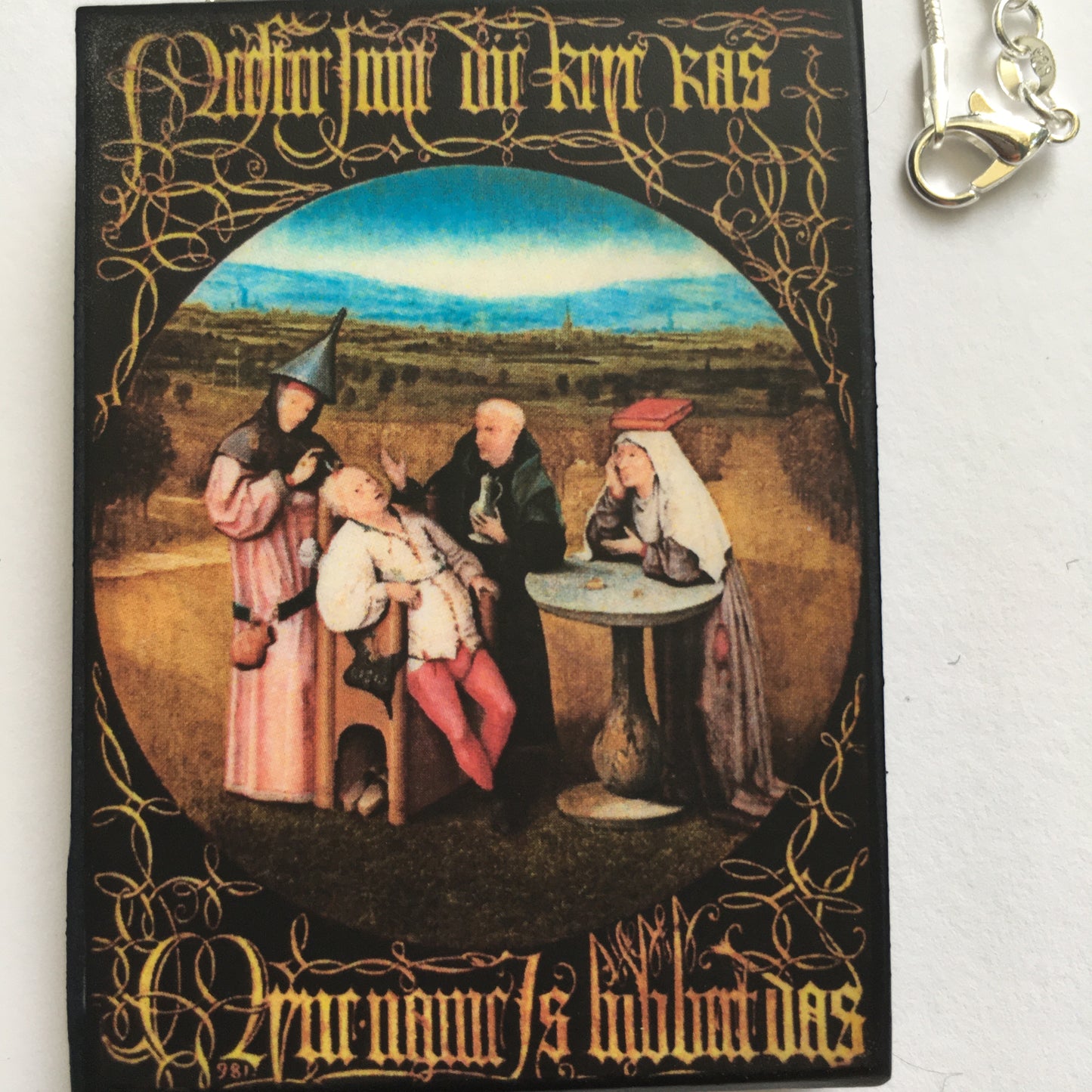 Hieronymus Bosch painting Cutting the Stone on top of this sustainable wood pendant with 925 sterling silver snake chain.