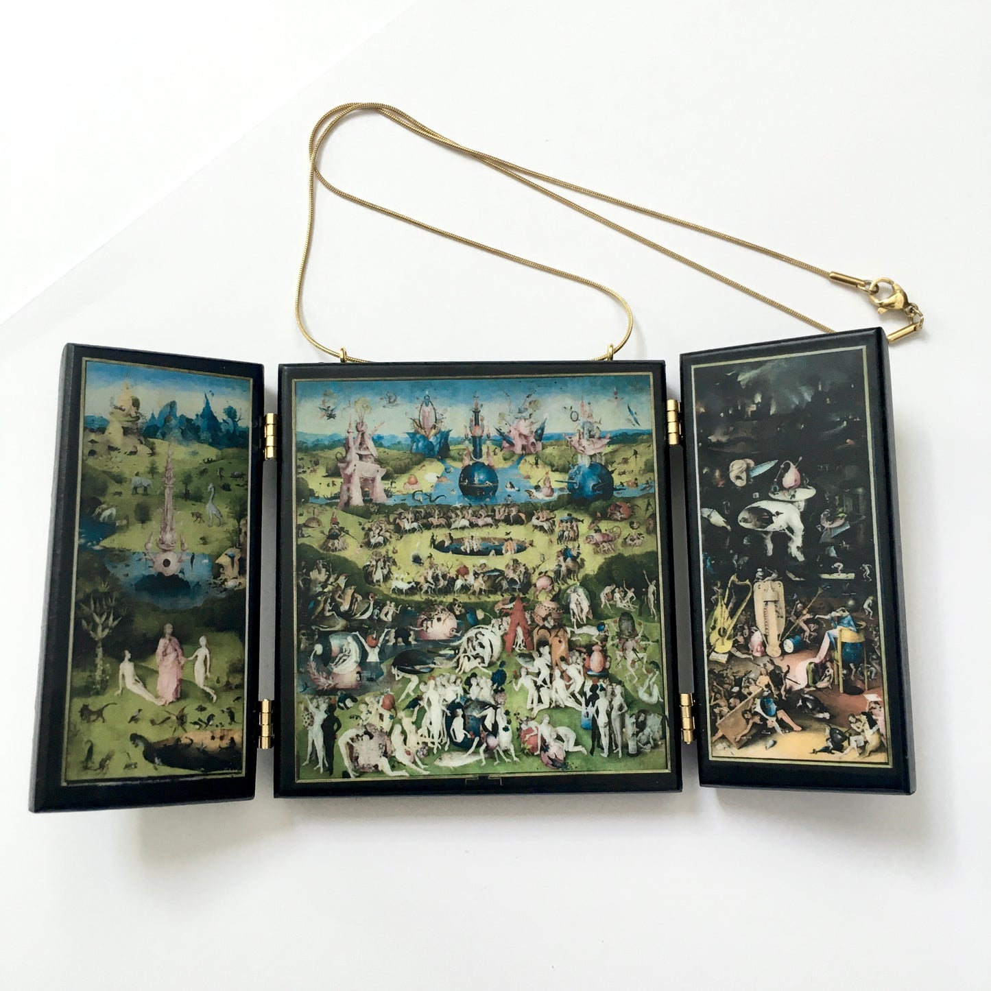 A fully functioning, reproduction in miniature of the three panelled masterpiece, Garden of Earthly Delights by Hieronymus Bosch, turned into a beguiling necklace.