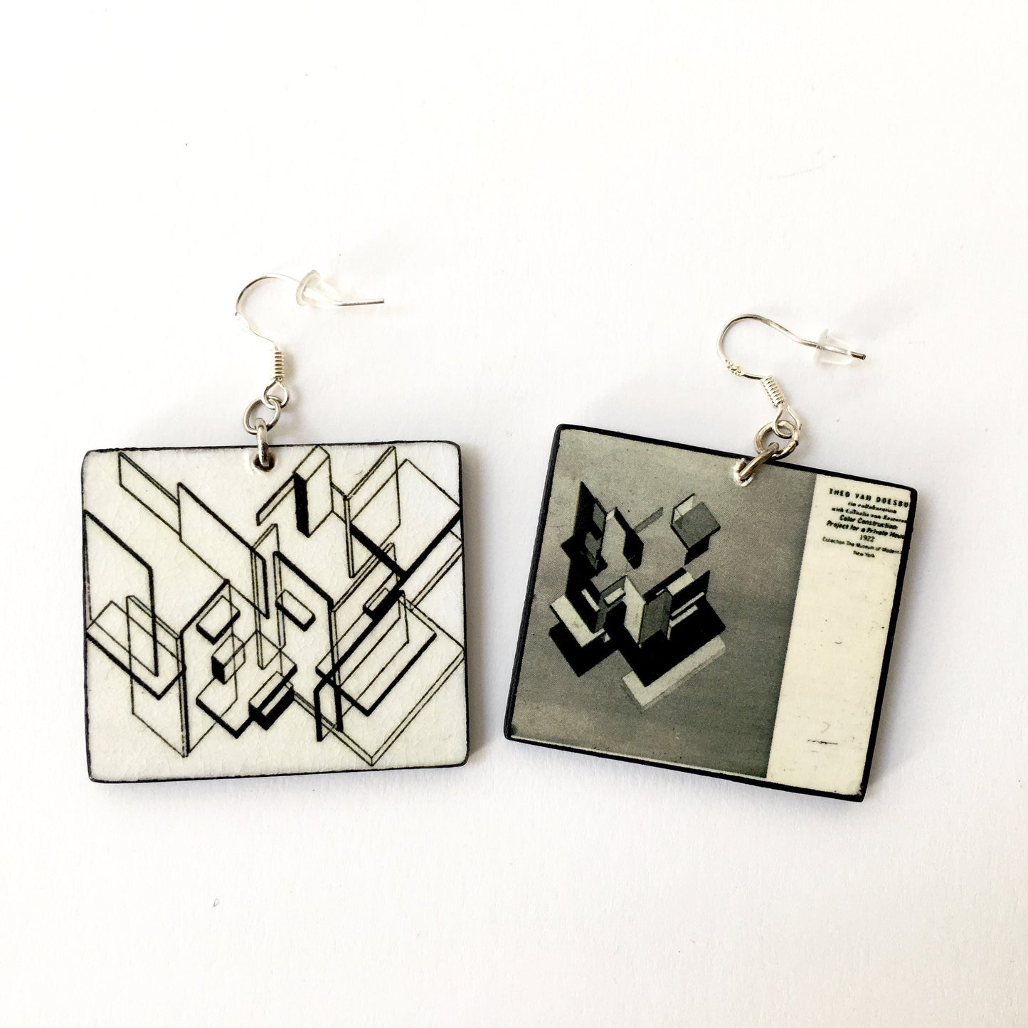 Mismatched, architectonic earring inspired by Theo Van Doesburg, De Stijl style with black and white geometric architecture planes. Obljewellery sustainable wood earrings