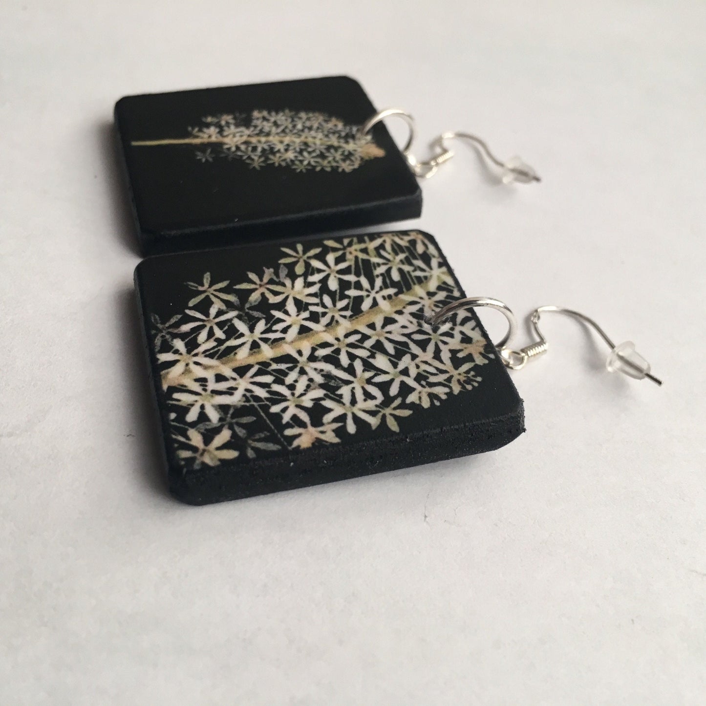 Obljewellery sustainable art earrings. These aesthetic earrings are on wood in black and white flowers a botanical artwork by Mary Delany. The earings are an artsy gift for her.