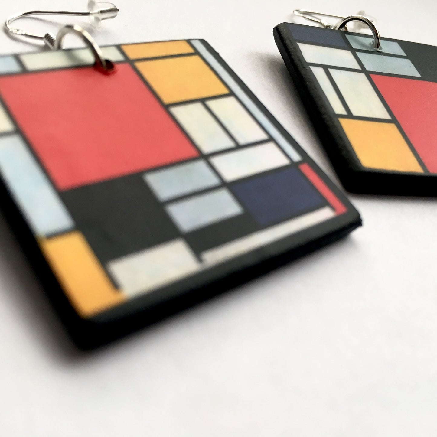 Mismatched earrings inspired by Mondrian.