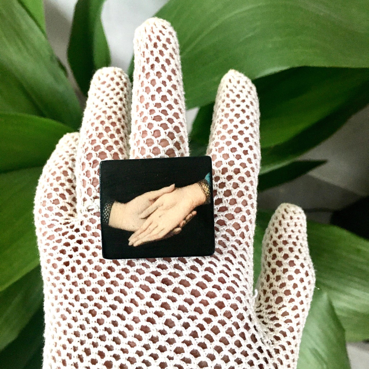 Sustainable statement earrings on wood with an art detail of the Andolfini hands. Renaissance painting “Arnolfini Portrait” by Jan van Eyck. Obljewellery art jewellery shop.