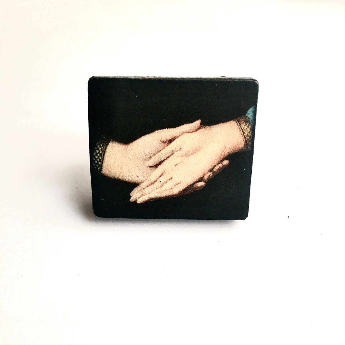 Sustainable statement earrings on wood with an art detail of the Andolfini hands. Renaissance painting “Arnolfini Portrait” by Jan van Eyck. Obljewellery art jewellery shop.