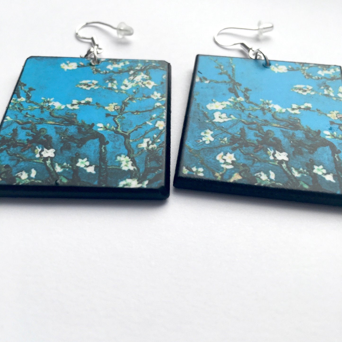 Sustainable wood earrings 4cm x 3.5 cm x 2/3 mm approx. Sterling silver 925 hooks. The Van Gogh artsy earrings are inspired by the masterpiece "Almond Blossom" where the artist painted one of his favourite subjects large flowering branches against a blue sky. The almond tree blooms is a symbol of new life, this painting was a gift for his brother Theo and his wife who had a son. Vincent Van Gogh was inspired by Japanese prints.