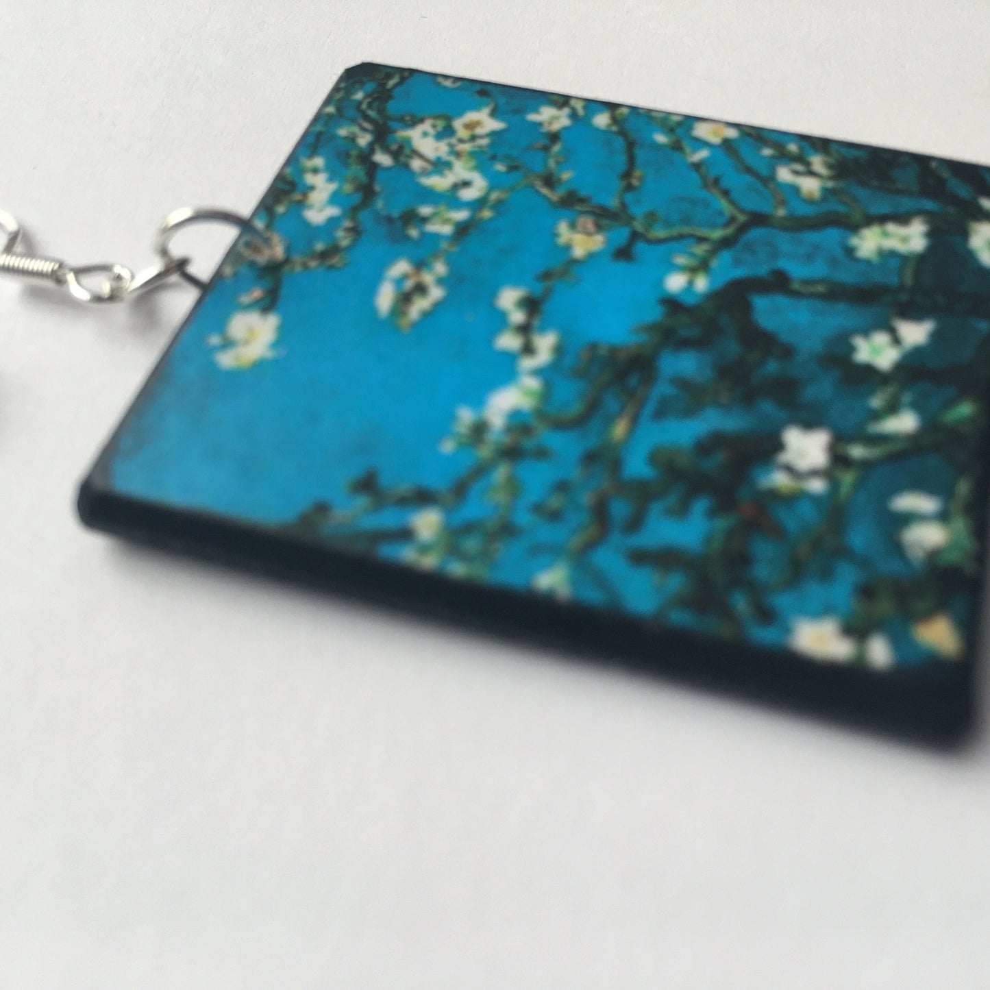 Sustainable wood earrings 4cm x 3.5 cm x 2/3 mm approx. Sterling silver 925 hooks. The Van Gogh artsy earrings are inspired by the masterpiece "Almond Blossom" where the artist painted one of his favourite subjects large flowering branches against a blue sky. The almond tree blooms is a symbol of new life, this painting was a gift for his brother Theo and his wife who had a son. Vincent Van Gogh was inspired by Japanese prints.