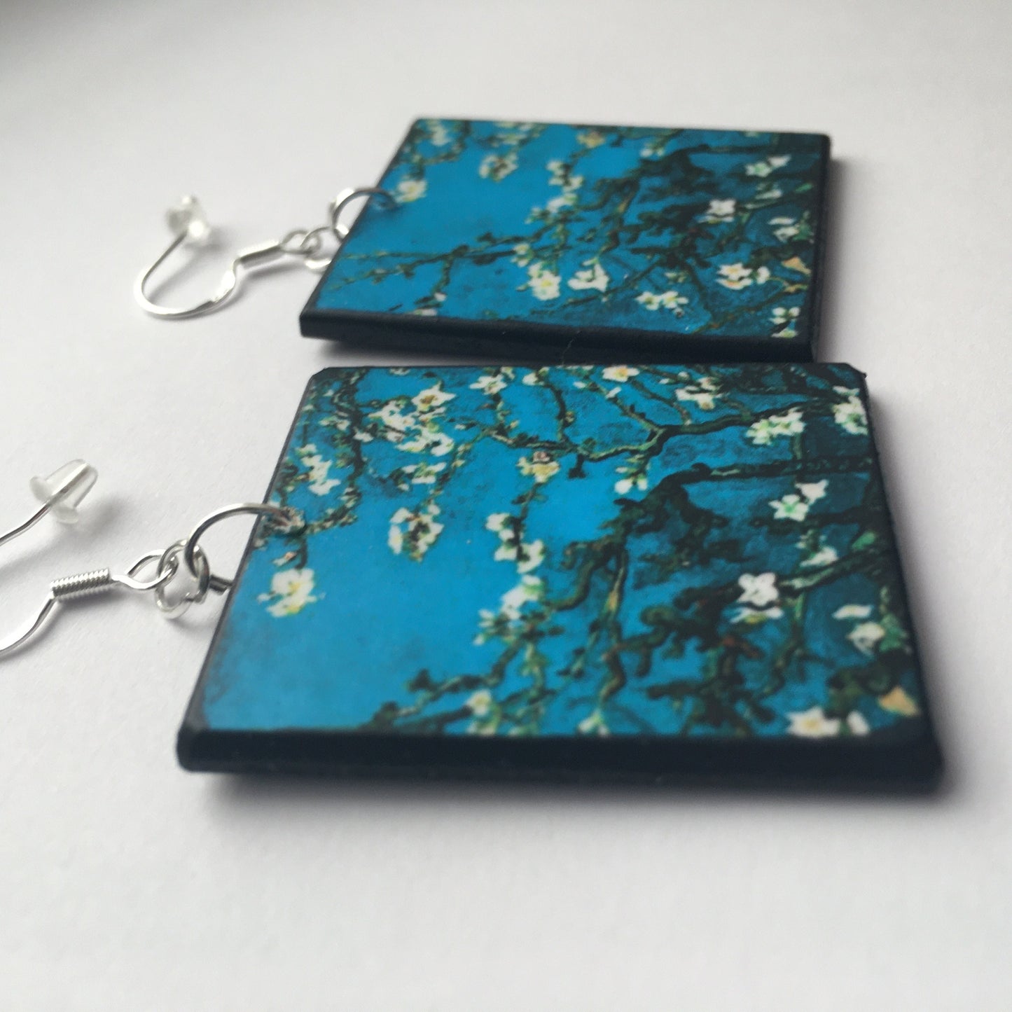Sustainable wood earrings 4cm x 3.5 cm x 2/3 mm approx. Sterling silver 925 hooks. The Van Gogh artsy earrings are inspired by the masterpiece "Almond Blossom" where the artist painted one of his favourite subjects large flowering branches against a blue sky. The almond tree blooms is a symbol of new life, this painting was a gift for his brother Theo and his wife who had a son. Vincent Van Gogh was inspired by Japanese prints.