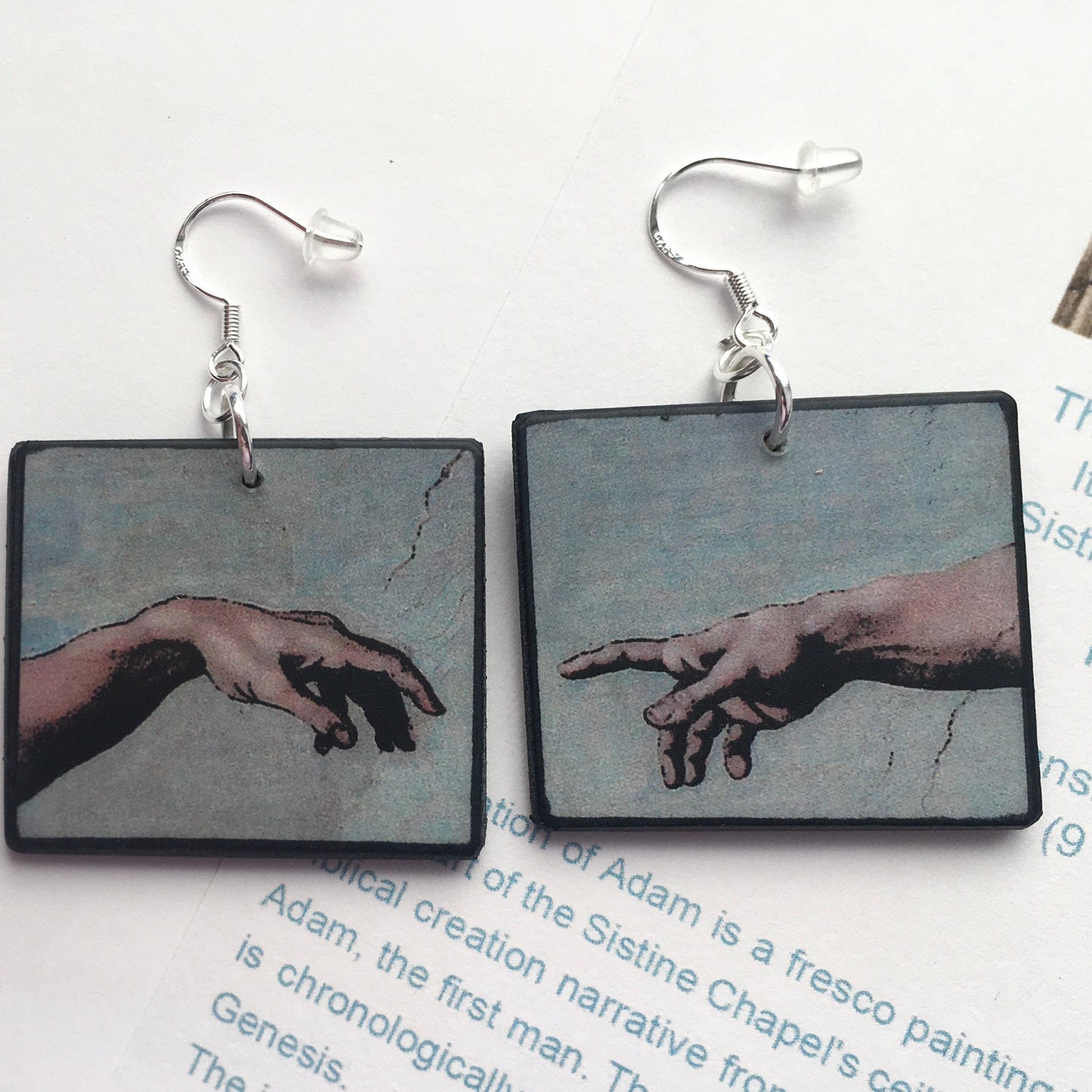 These earrings echo the famous scene of the Creation of Adam, frescoed in the Sistine Chapel by Michelangelo Buonarroti; Italian Renaissance artist. Handmade by Obljewellery from sustainable wood with sterling silver hooks.