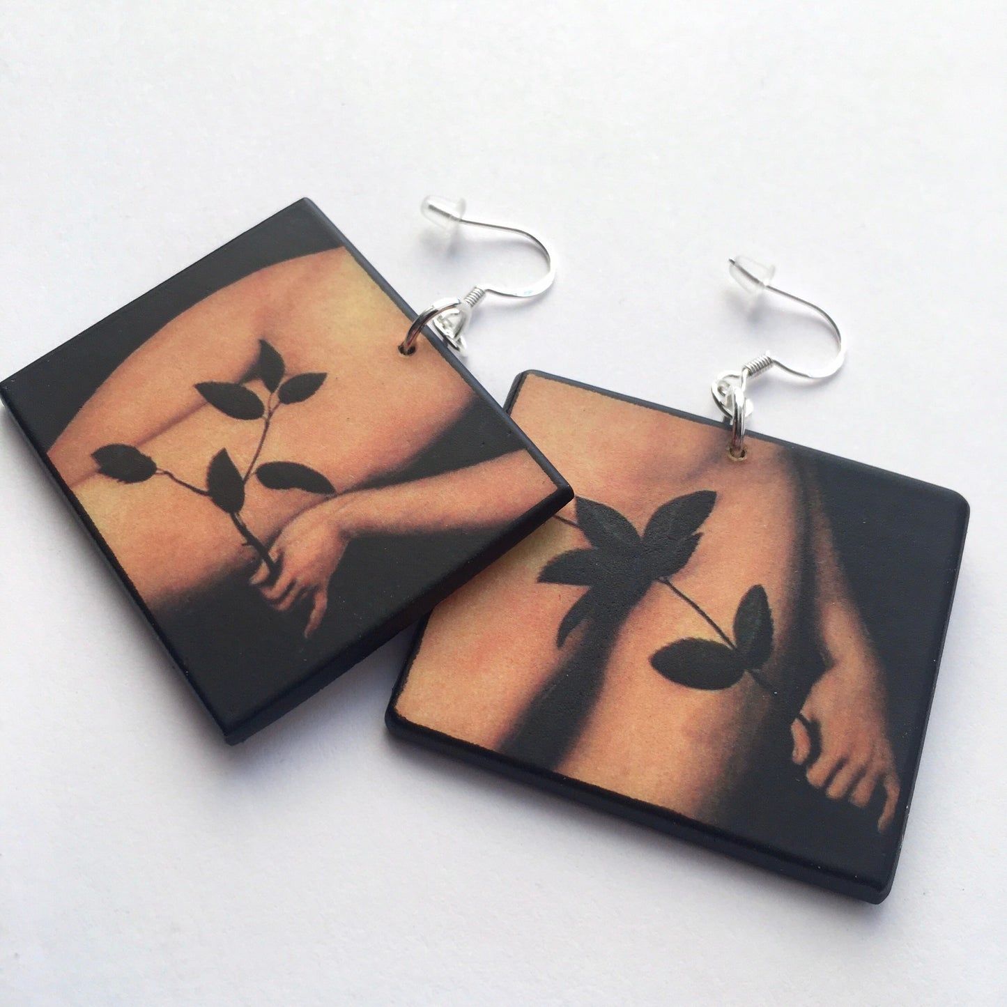 Lucas Cranach, Adam and Eve, mismatched earrings. Detail of the leaf in front of the nude body. The arrings are made with sostainable wood by Obljewellery.