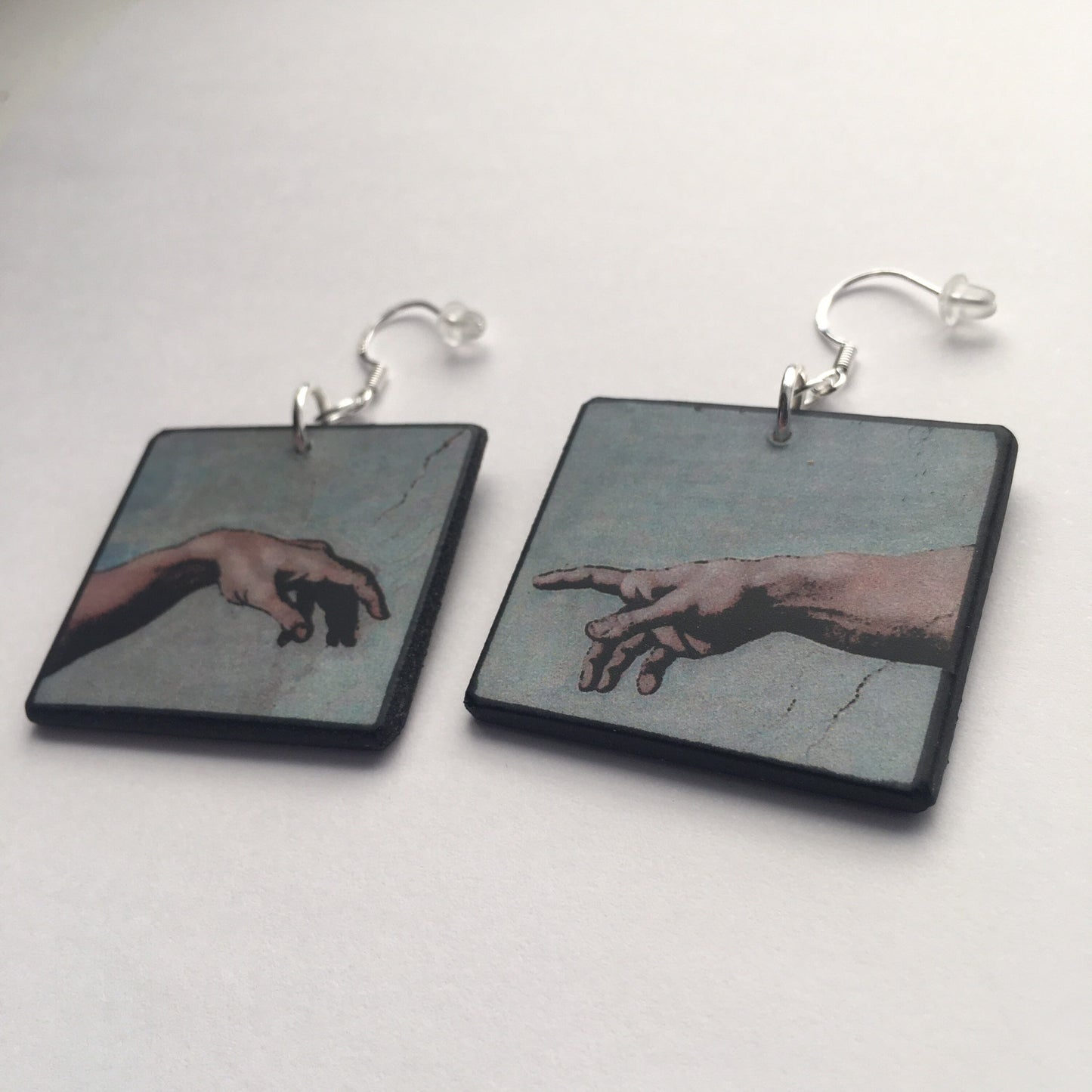 These earrings echo the famous scene of the Creation of Adam, frescoed in the Sistine Chapel by Michelangelo Buonarroti; Italian Renaissance artist. Handmade by Obljewellery from sustainable wood with sterling silver hooks.