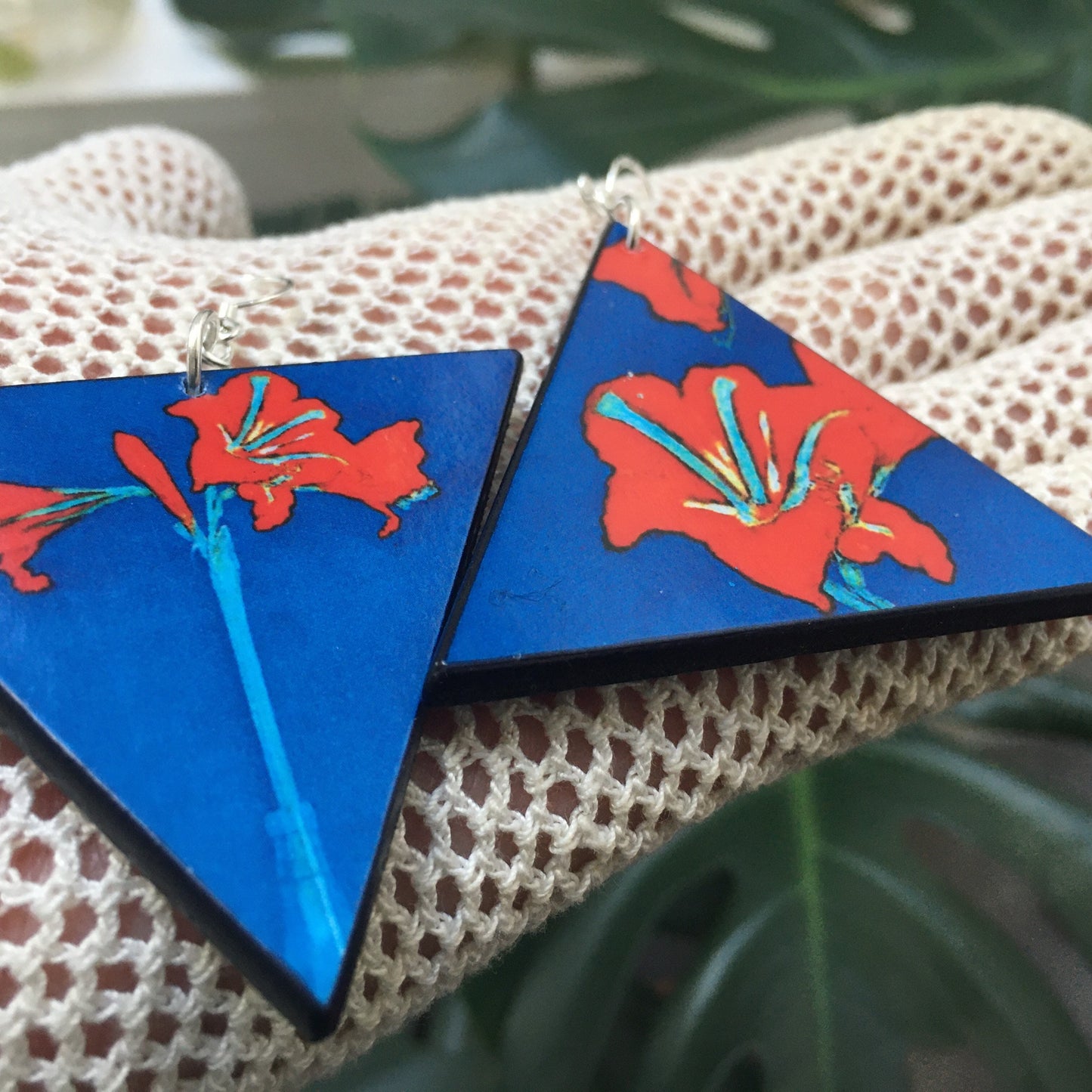 Triangle earrings with an art detail of Mondrian painting. Red flowers and blue color. Sustainable handmade earrings on wood by Obljewellery.