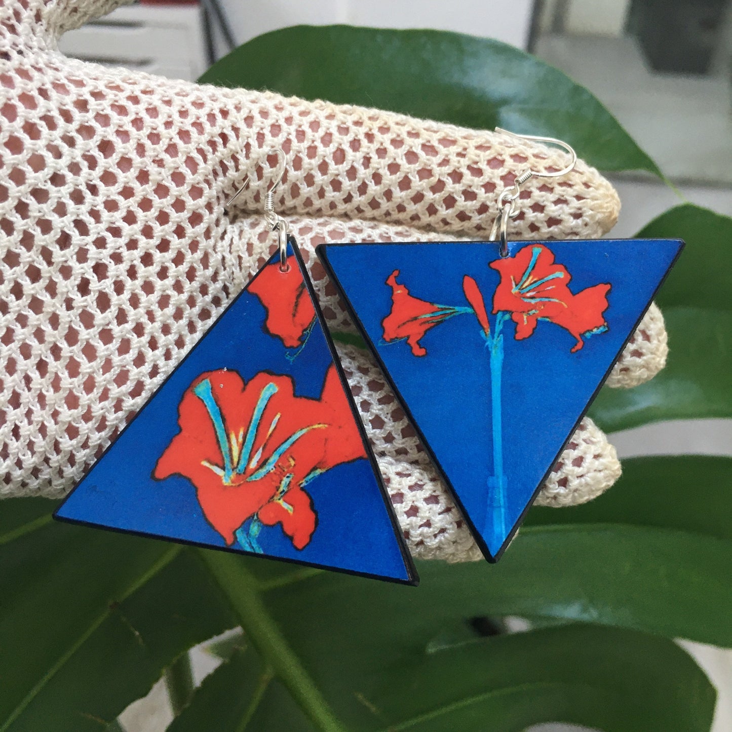Triangle earrings with an art detail of Mondrian painting. Red flowers and blue color. Sustainable handmade earrings on wood by Obljewellery.