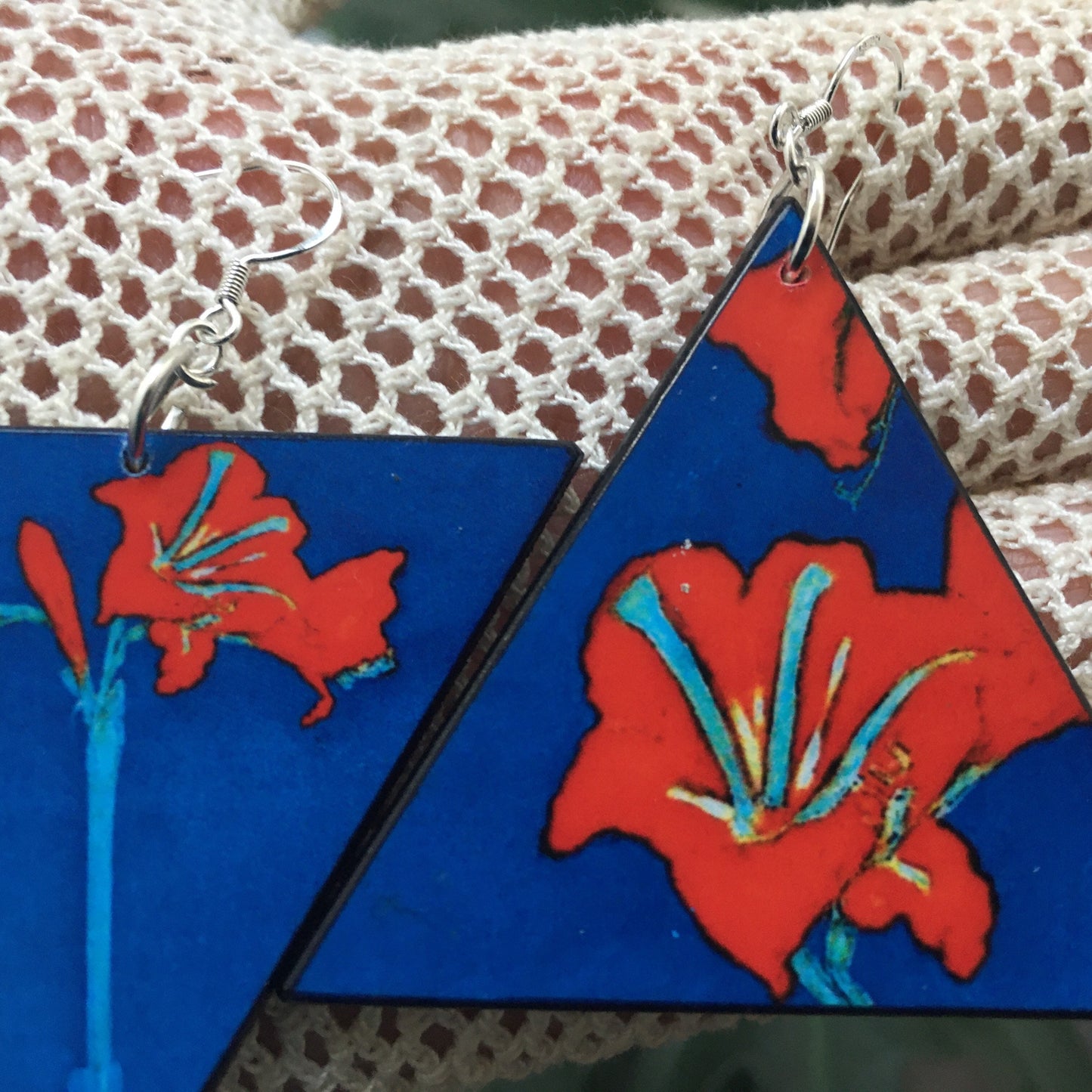 Triangle earrings with an art detail of Mondrian painting. Red flowers and blue color. Sustainable handmade earrings on wood by Obljewellery.