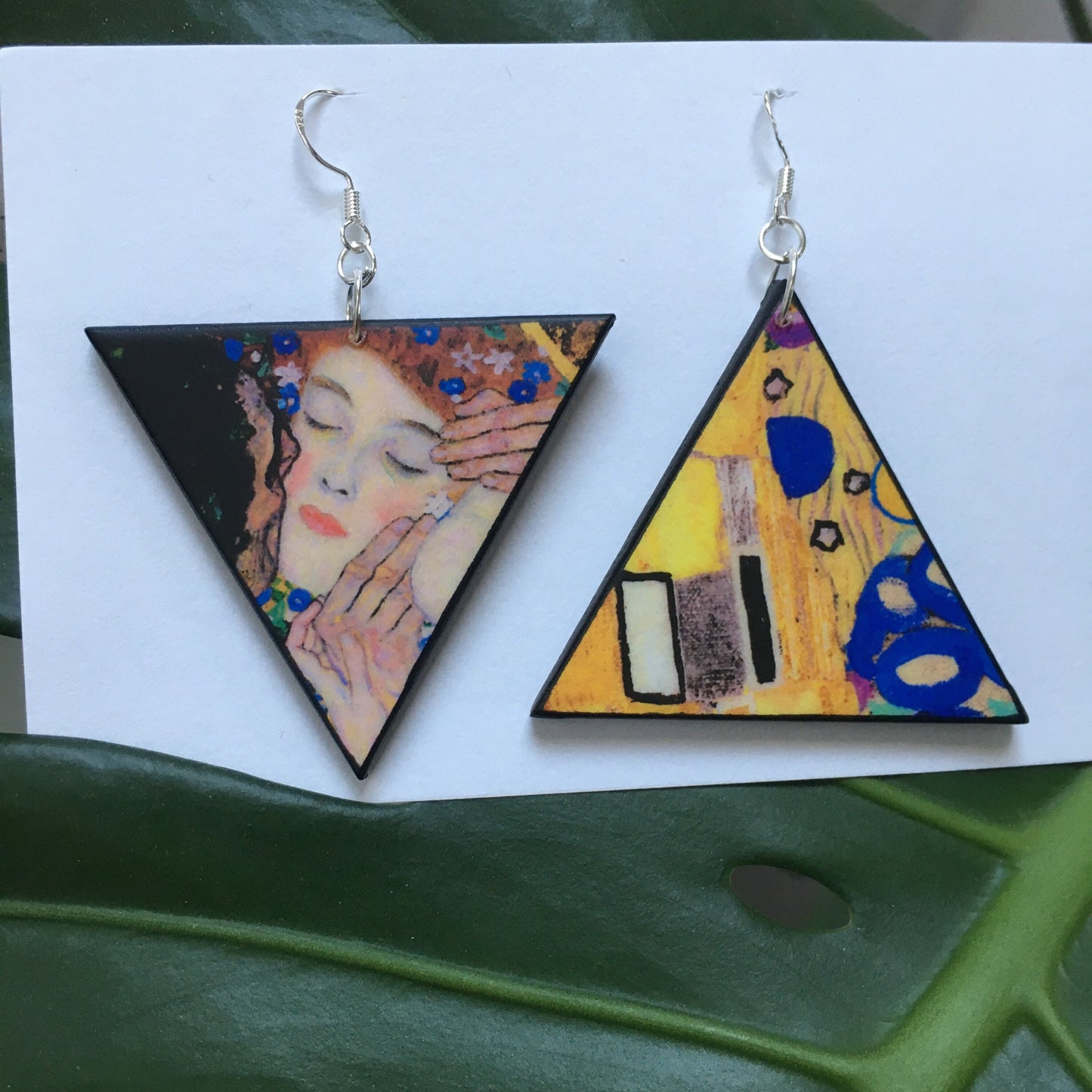 triangular wooden earrings with Klimt art details.