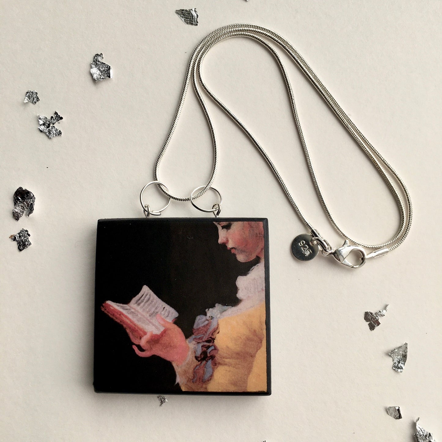 Statement pendant on sustainable wood with the art image “Young Girl Reading” Sterling silver snake chain. Whimsical necklace. Sustainable gift.