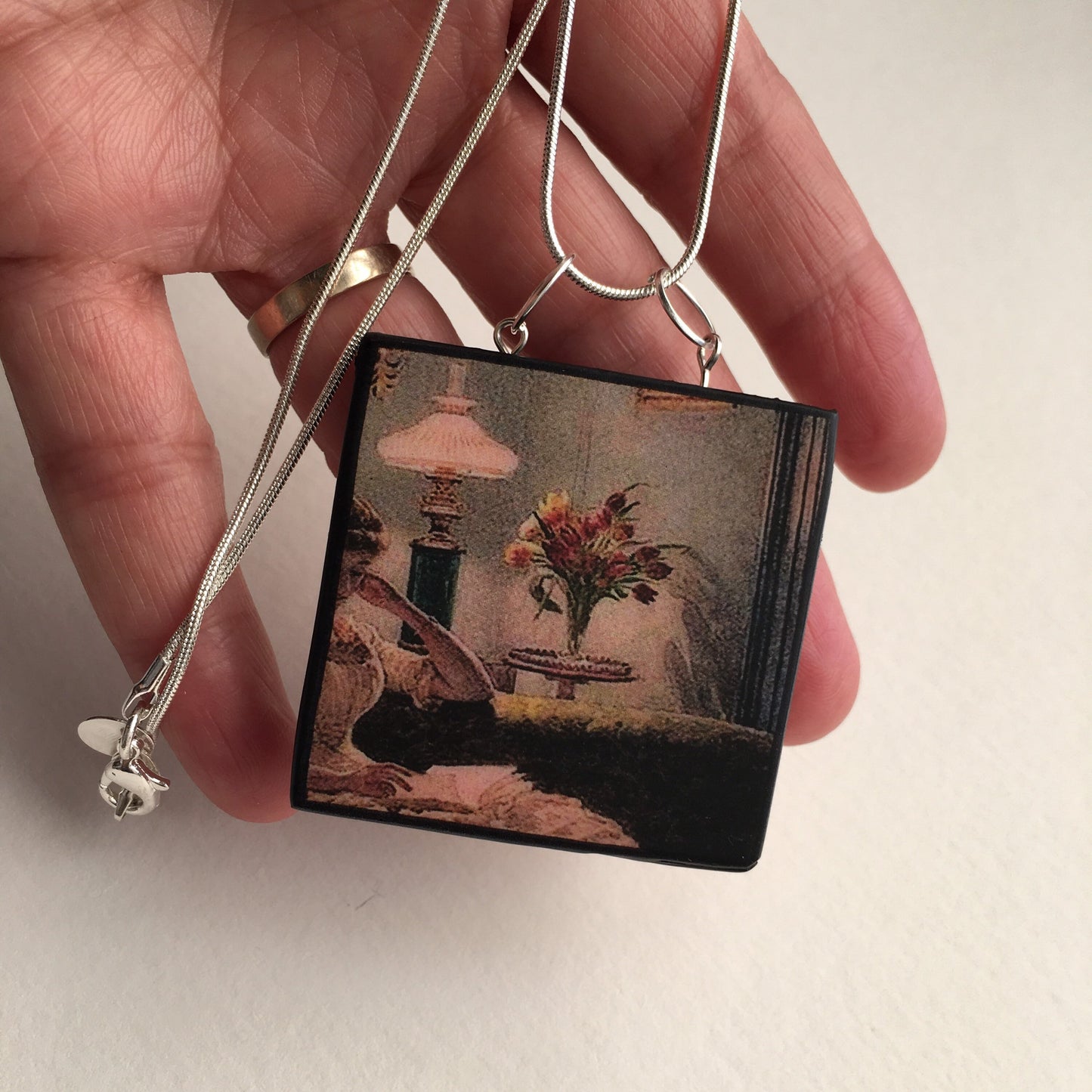Victorian art detail painting “An Evening at Home” 1888. by Edward John Poynter on this sustainable, statement, wood pendant with sterling silver necklace, handmade by Obljewellery, artsy and aesthetic gift shop.