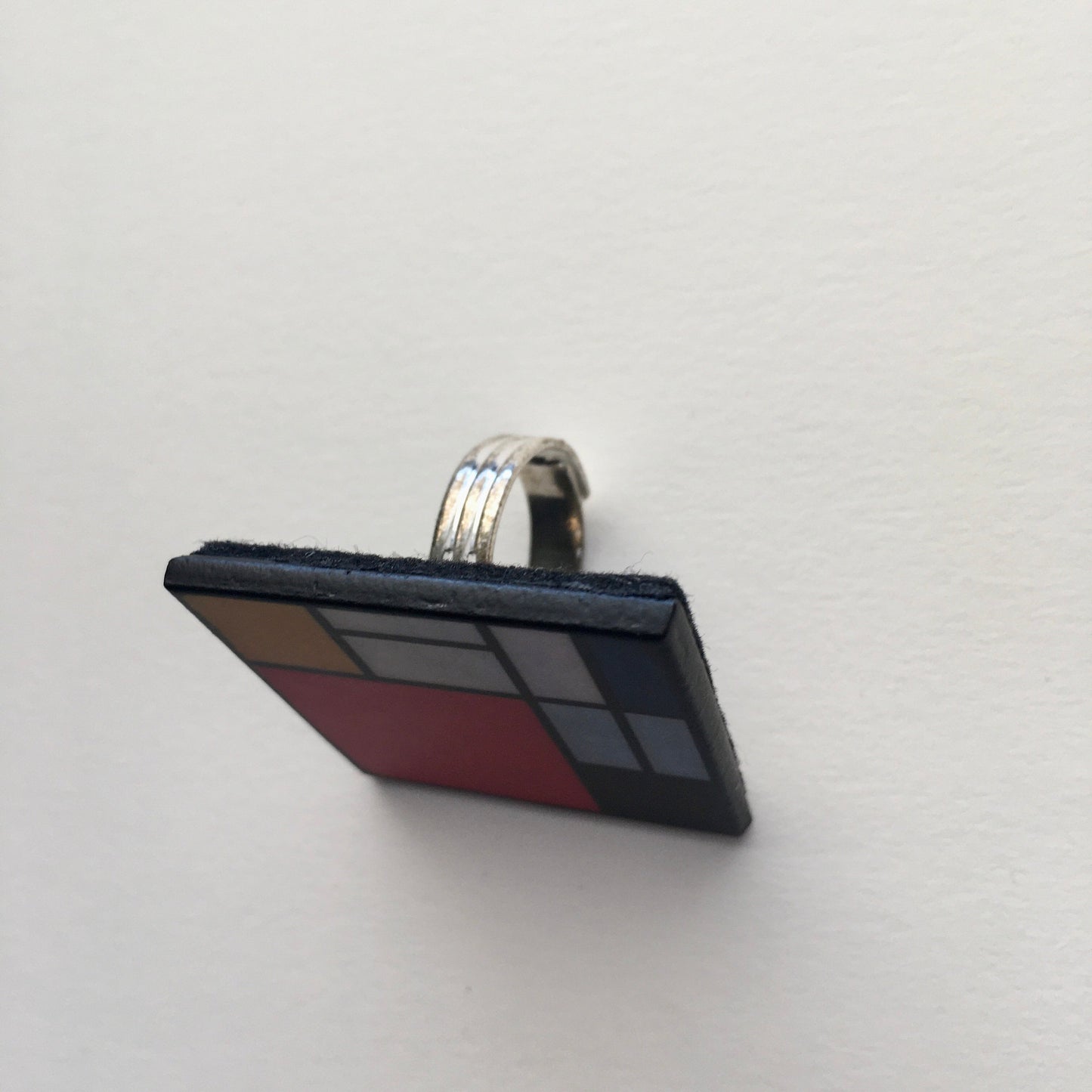 Wooden, 3.5 cm squared geometric art ring in red, blue, yellow and white colors. Obljewellery shop is inspired by Mondrian's De Stijl period works.