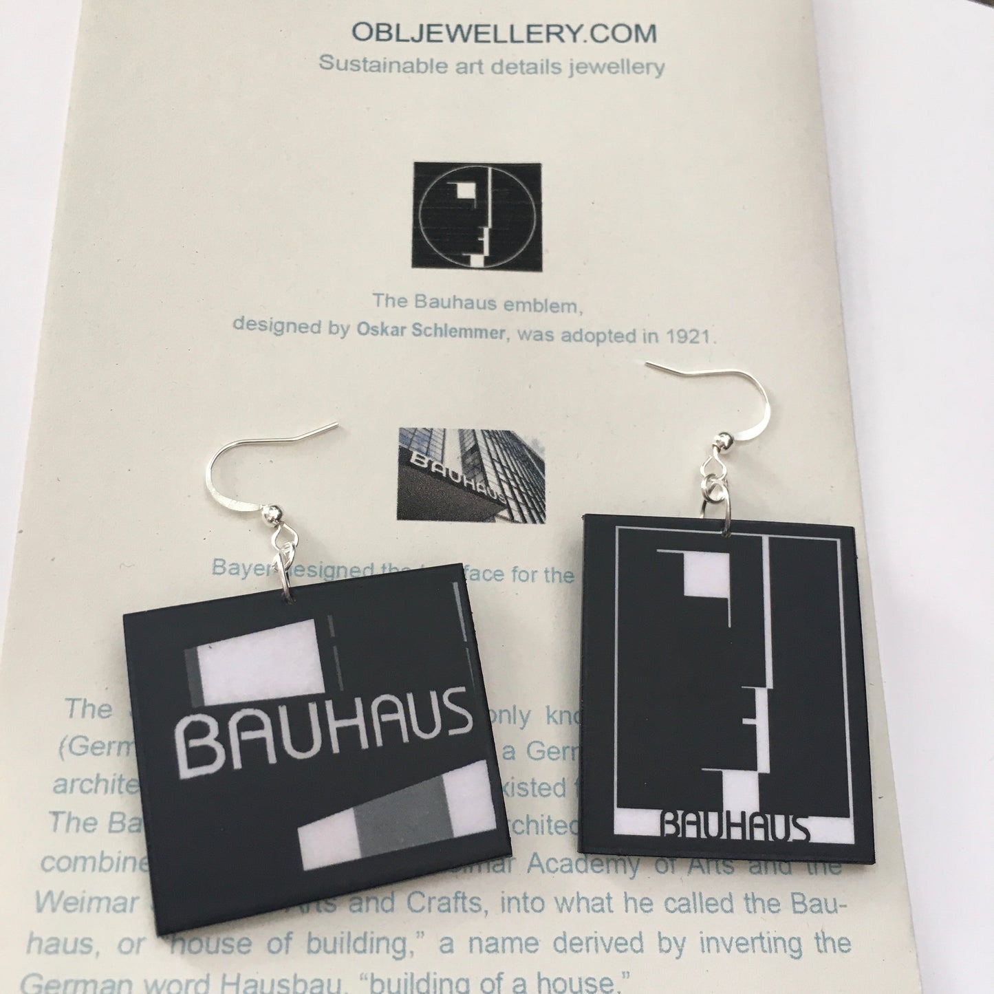 Sustainable, asymmetrical art earrings inspired by the Bauhaus emblem, designed by Oskar Schlemmer.