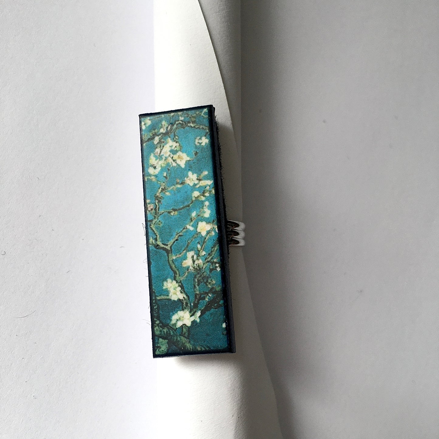 Inspired by the Van Gogh painting Almond Blossom, Obljewellery handmade from sustainable wood this rectangular ring with adjustable silver colour band ring. White flowers against turquoise sky.