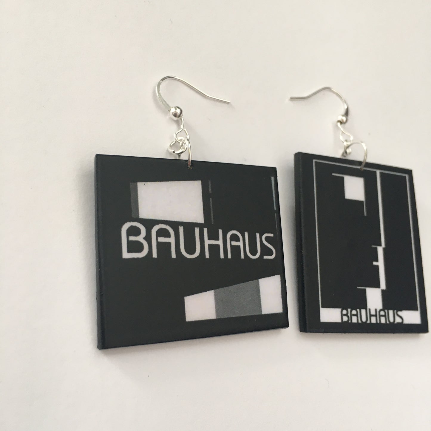 Sustainable, asymmetrical art earrings inspired by the Bauhaus emblem, designed by Oskar Schlemmer.
