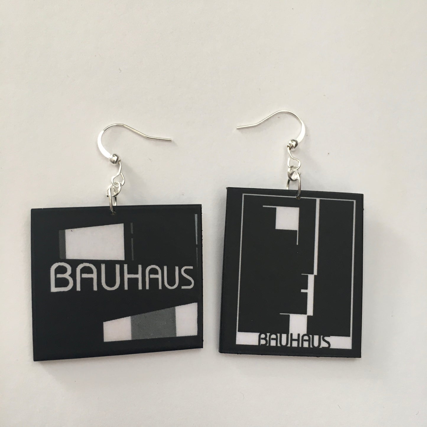 Sustainable, asymmetrical art earrings inspired by the Bauhaus emblem, designed by Oskar Schlemmer.