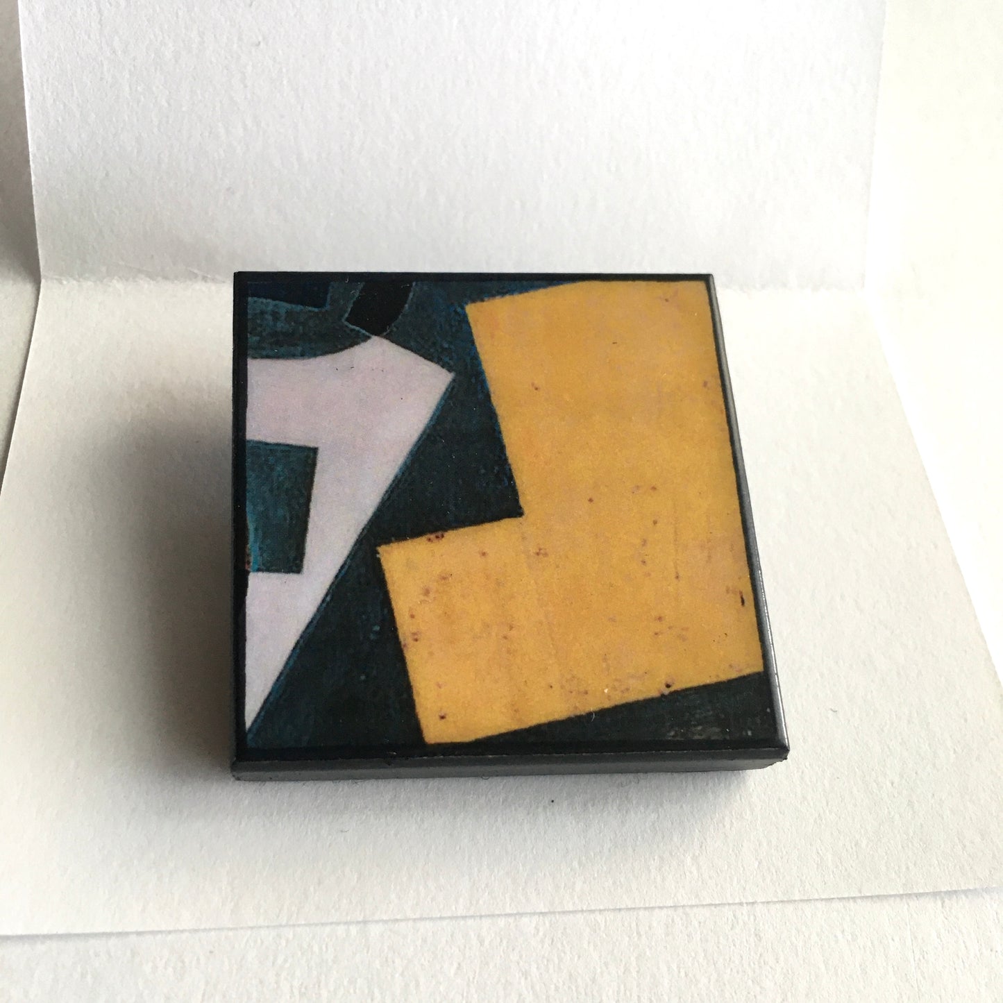 Art detail from Cubism painting by Spanish artist Juan Gris. Sustainable square brooch handmade from wood by Obljewellery