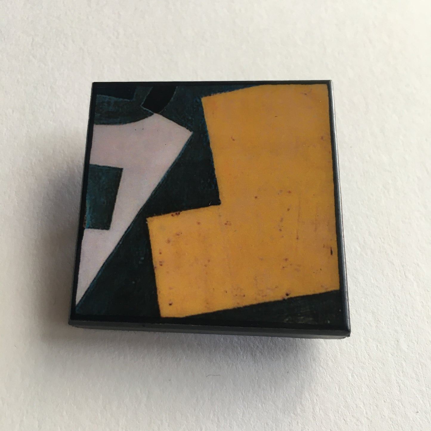 Art detail from Cubism painting by Spanish artist Juan Gris. Sustainable square brooch handmade from wood by Obljewellery
