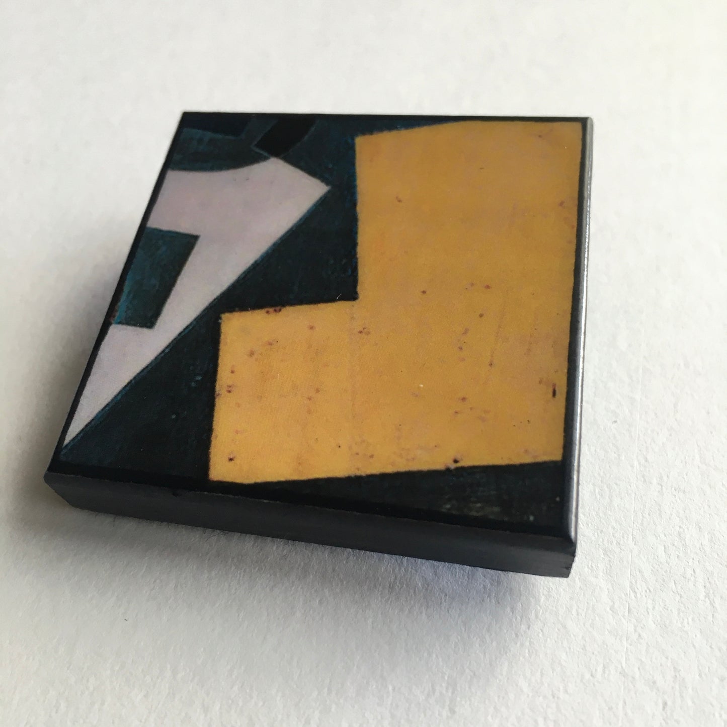 Art detail from Cubism painting by Spanish artist Juan Gris. Sustainable square brooch handmade from wood by Obljewellery