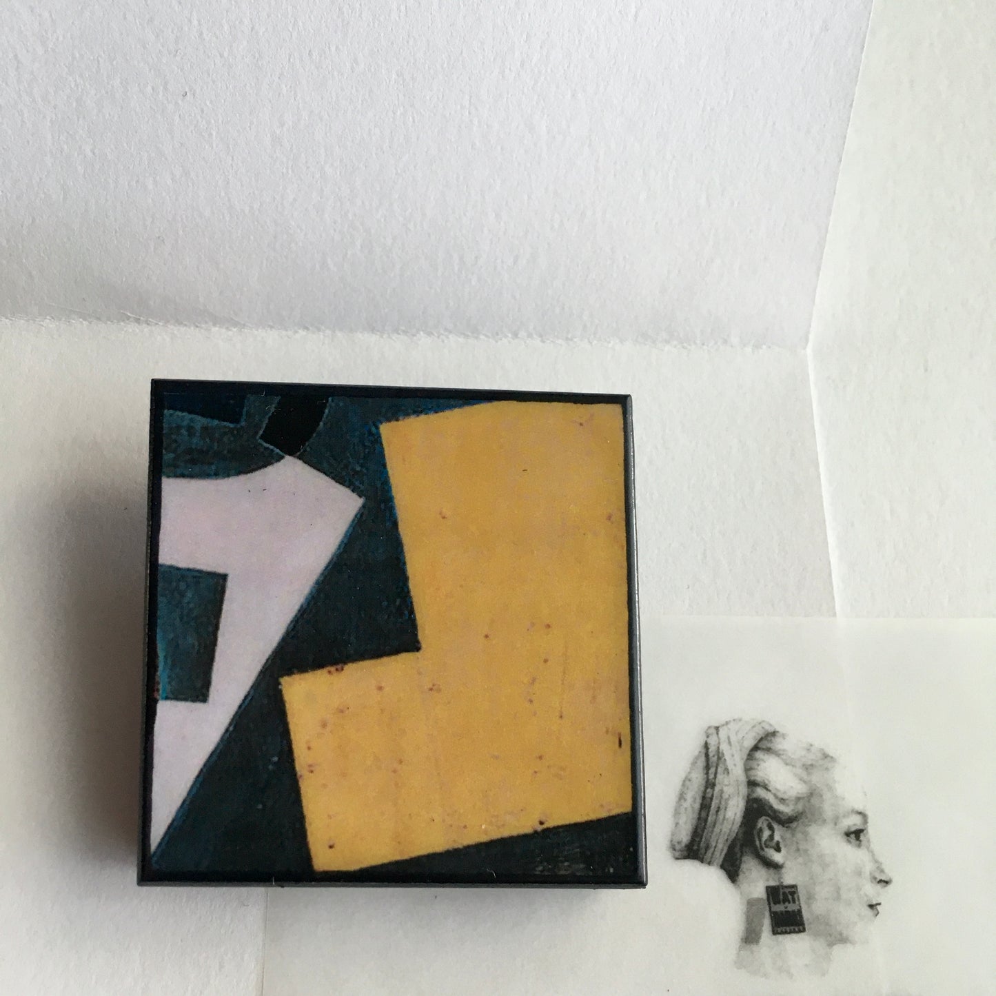 Art detail from Cubism painting by Spanish artist Juan Gris. Sustainable square brooch handmade from wood by Obljewellery