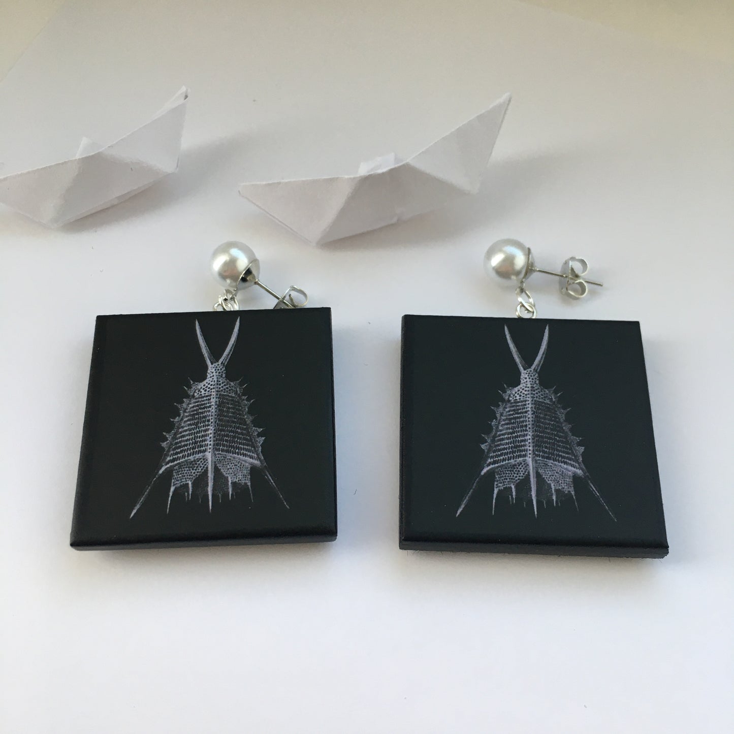 Sustainable wood earrings with stud pearls inspired by Ernst Haeckel marine shells, radiolaria black and white illustration. These earrings are completely handmade by Obljewellery