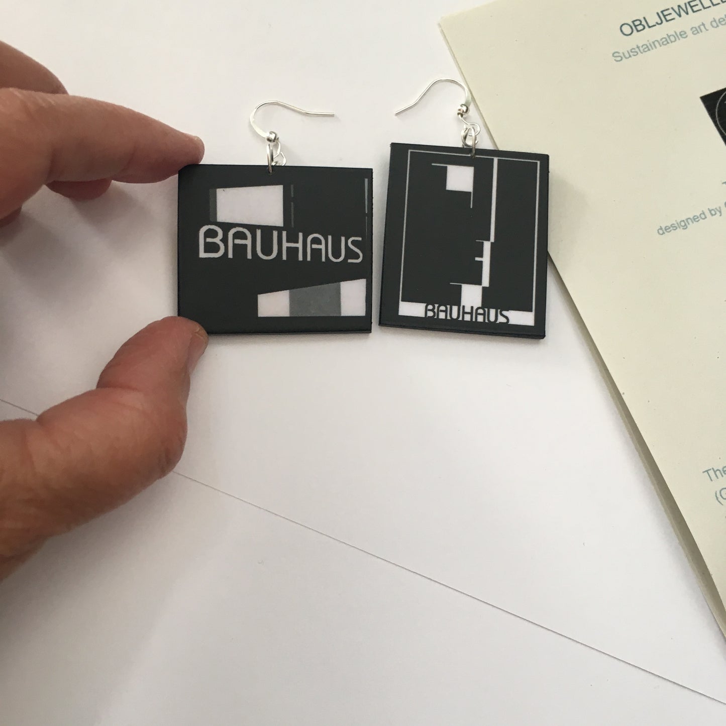 Sustainable, asymmetrical art earrings inspired by the Bauhaus emblem, designed by Oskar Schlemmer.