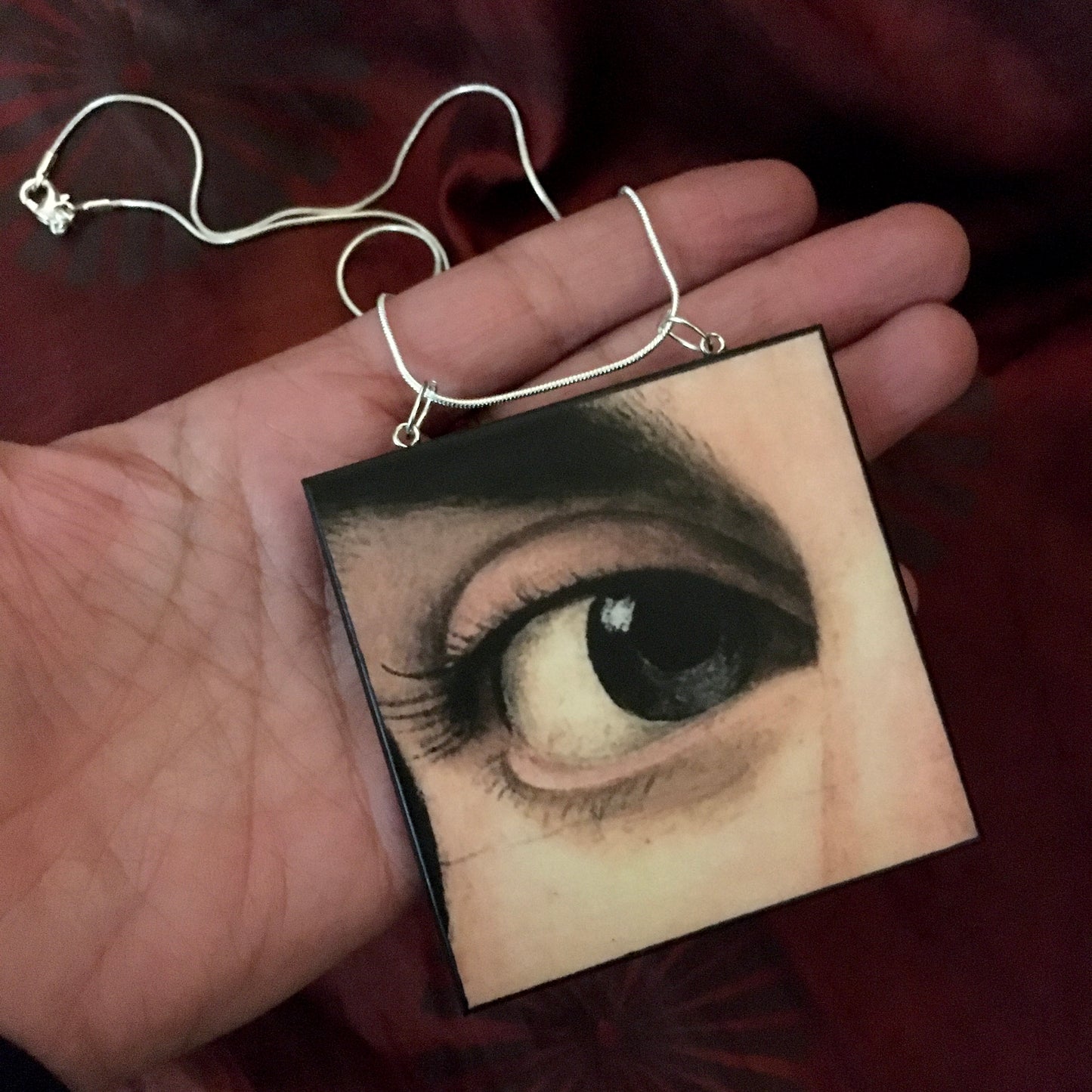 Sustainable wood pendant with an eye detail taken from a Renaissance art painting by Antonello da Messina. Handmade by Obljewellery