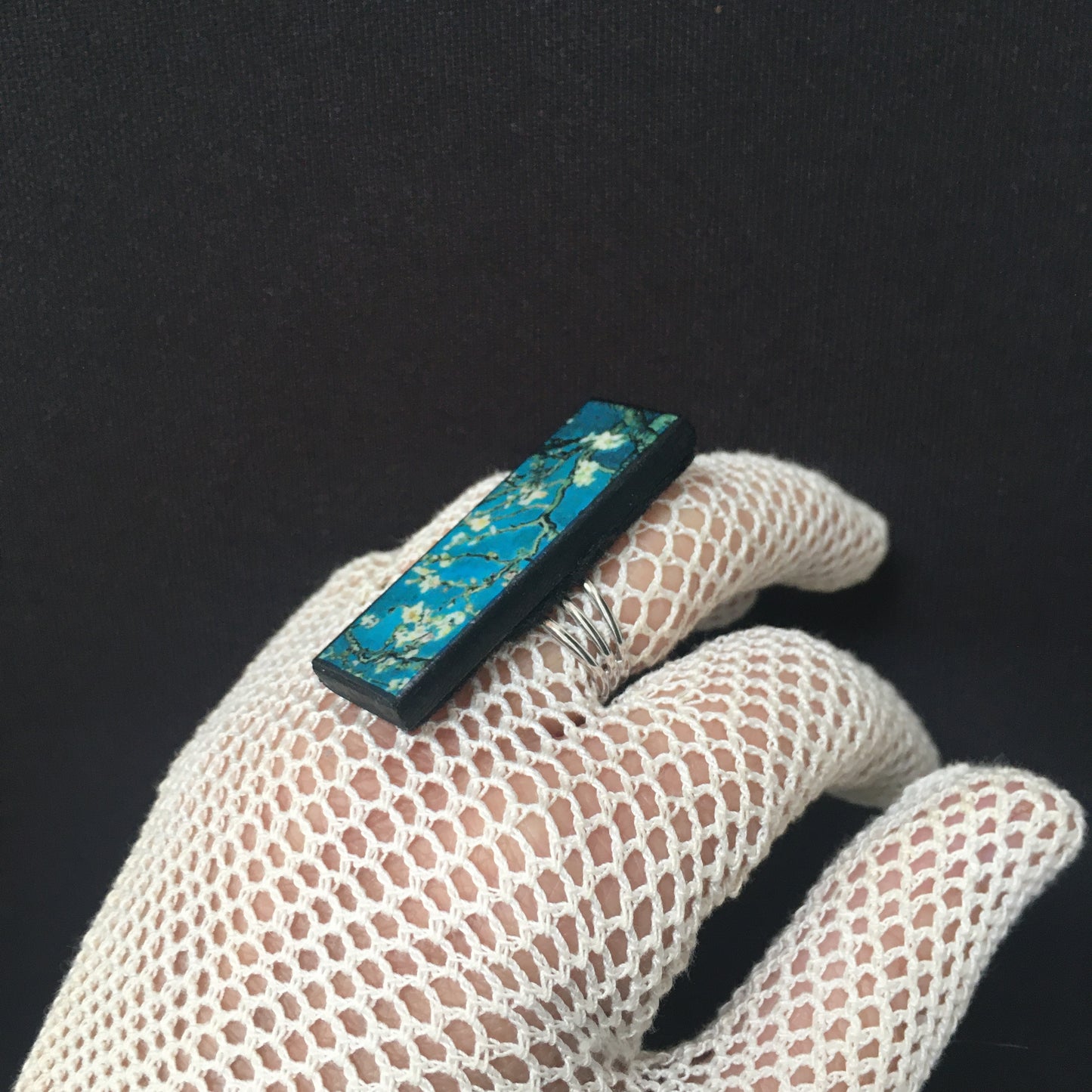 Inspired by the Van Gogh painting Almond Blossom, Obljewellery handmade from sustainable wood this rectangular ring with adjustable silver colour band ring. White flowers against turquoise sky.