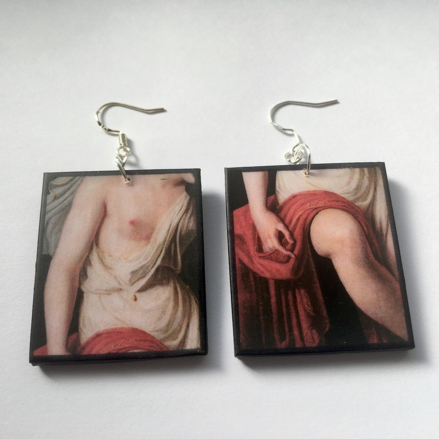 Sensual art earrings on sustainable wood. Mismatched earrings with art details of Sappho nude body. obljewellery artsy gift jewellery.