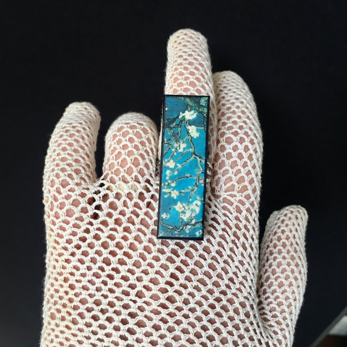 Inspired by the Van Gogh painting Almond Blossom, Obljewellery handmade from sustainable wood this rectangular ring with adjustable silver colour band ring. White flowers against turquoise sky.