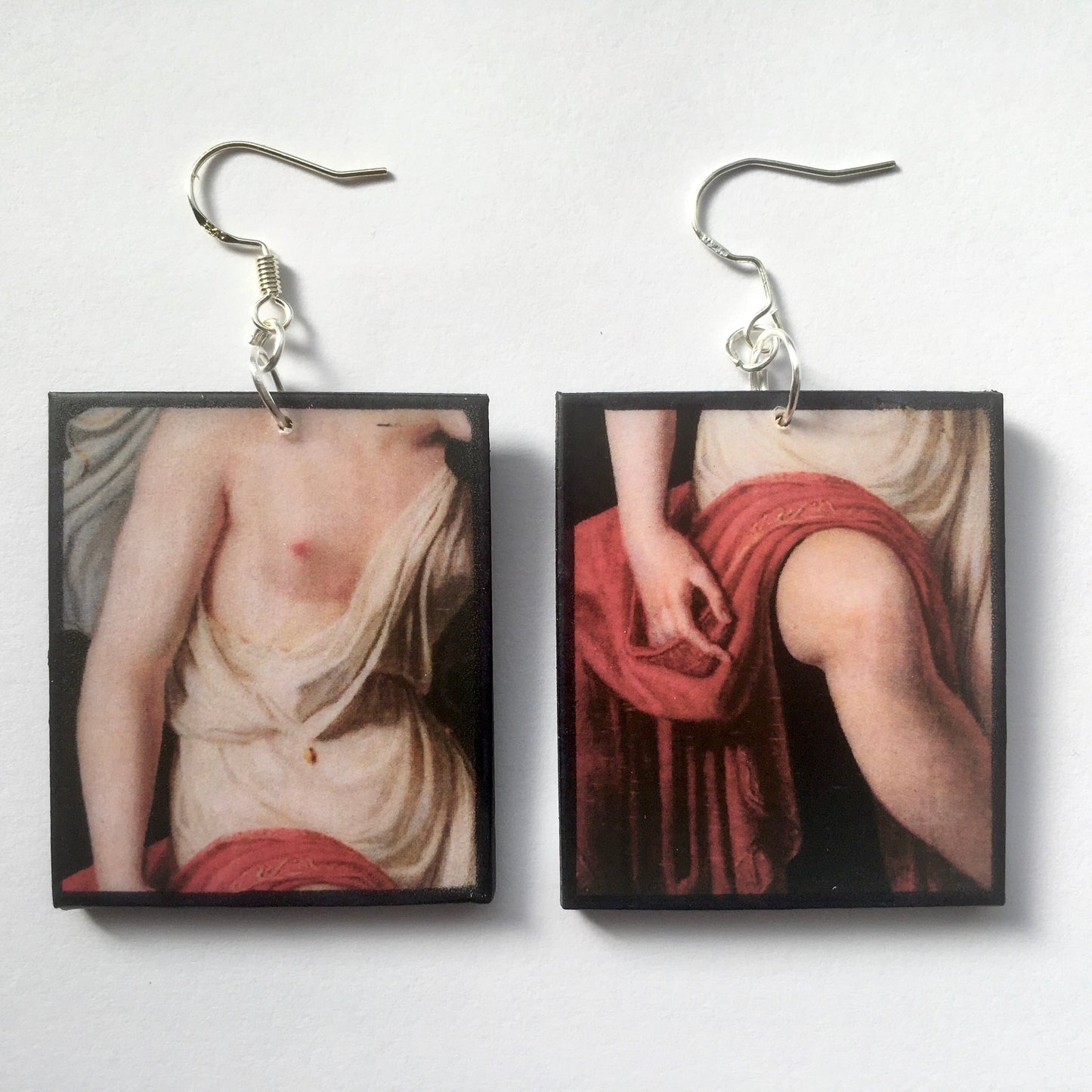Sensual art earrings on sustainable wood. Mismatched earrings with art details of Sappho nude body. obljewellery artsy gift jewellery.