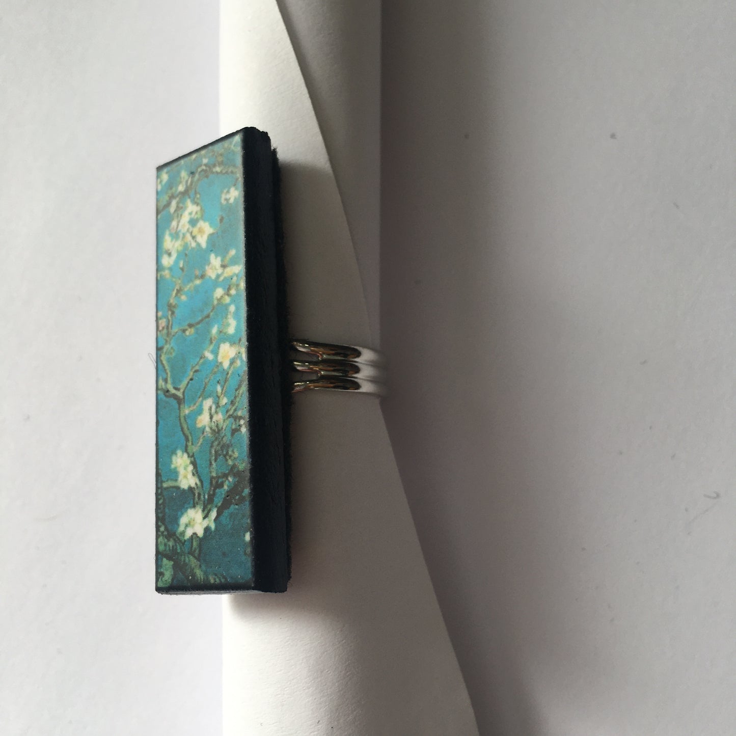 Inspired by the Van Gogh painting Almond Blossom, Obljewellery handmade from sustainable wood this rectangular ring with adjustable silver colour band ring. White flowers against turquoise sky.