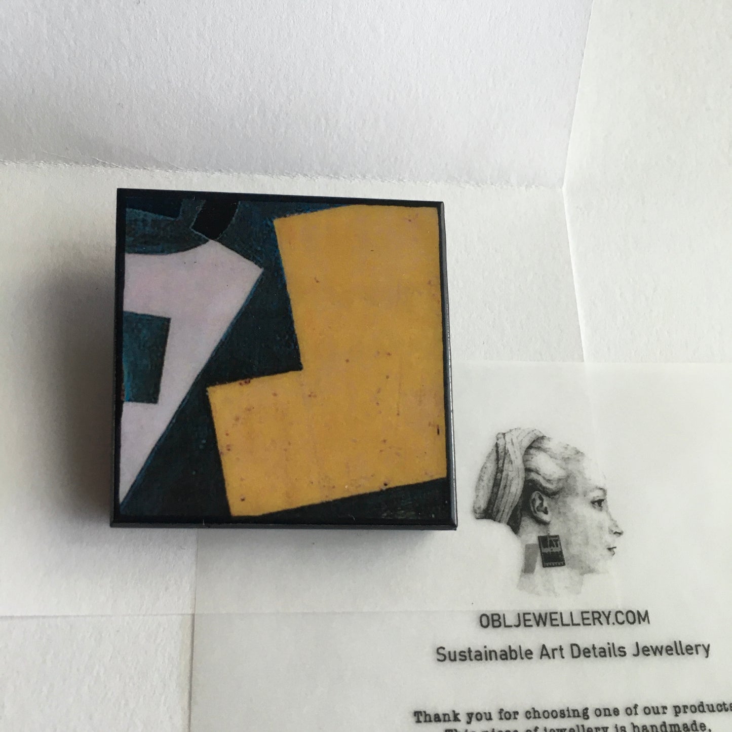 Art detail from Cubism painting by Spanish artist Juan Gris. Sustainable square brooch handmade from wood by Obljewellery
