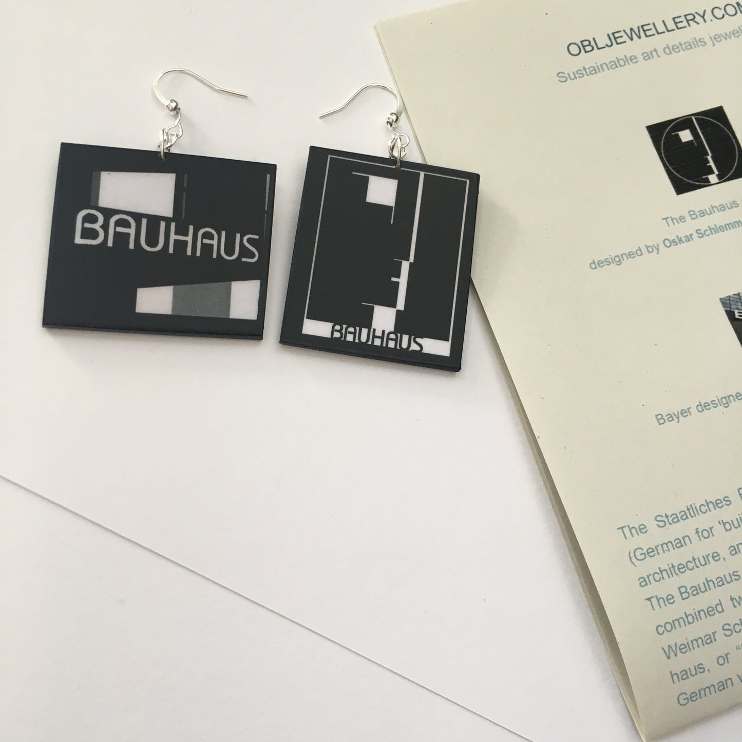 Sustainable, asymmetrical art earrings inspired by the Bauhaus emblem, designed by Oskar Schlemmer.