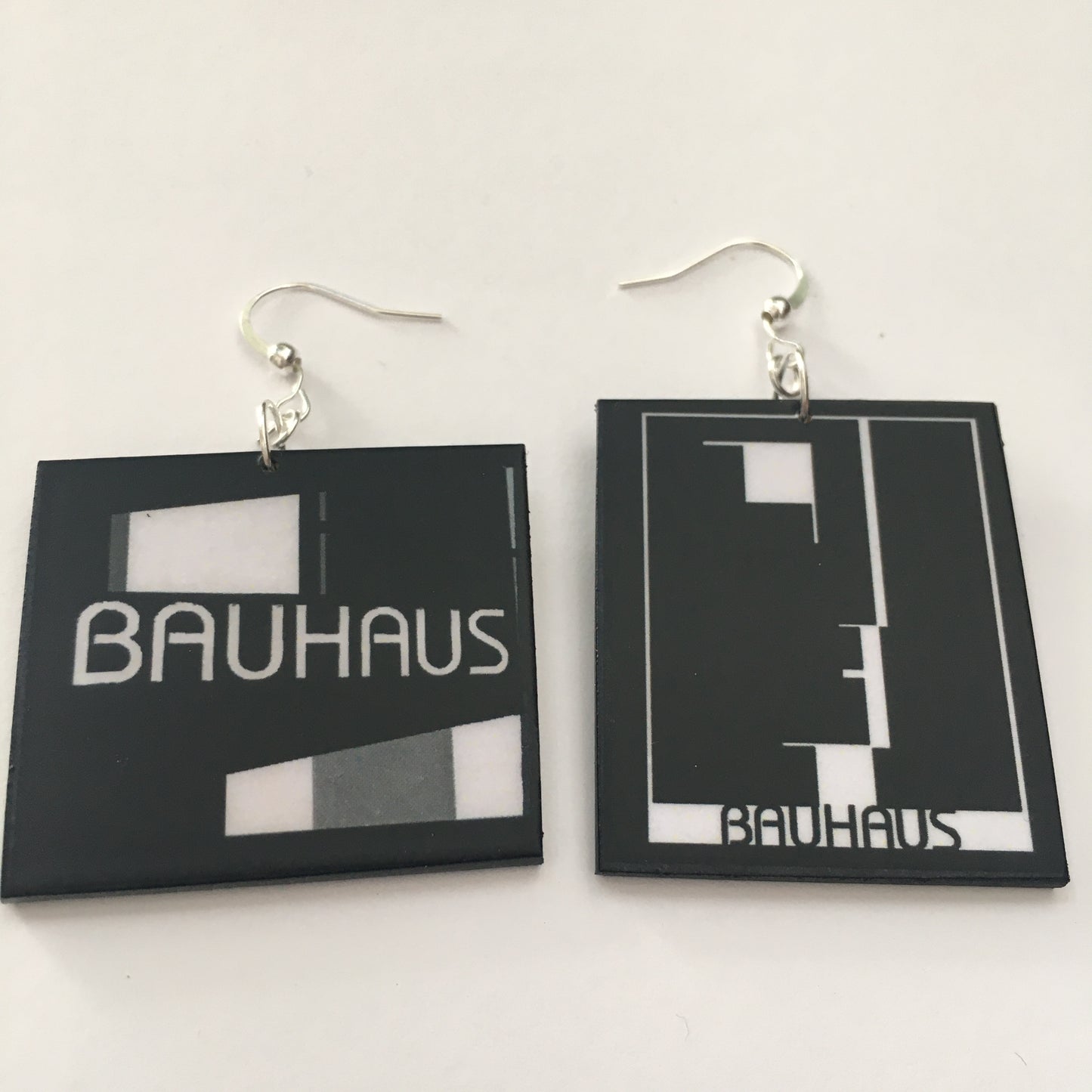 Sustainable, asymmetrical art earrings inspired by the Bauhaus emblem, designed by Oskar Schlemmer.