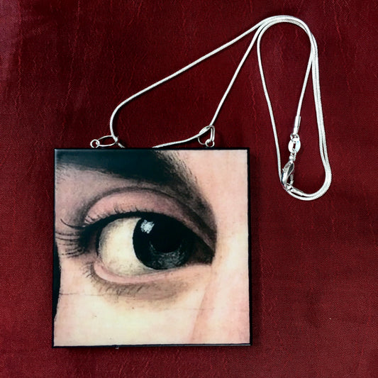 Sustainable wood pendant with an eye detail taken from a Renaissance art painting by Antonello da Messina. Handmade by Obljewellery