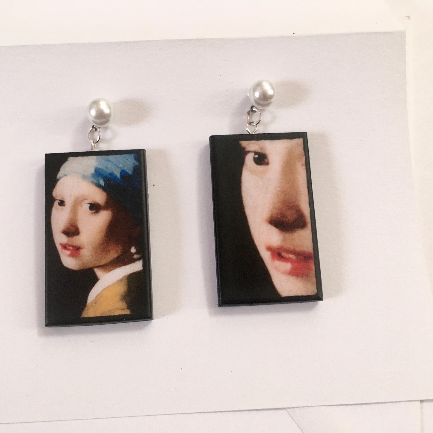 The girl with a pearl earring is a painting by Vermeer. These art details earring show the face of the girl they are in sustainable weood and have the stud earrings with pearls. Handmade mismatched earrings by Obljewellery