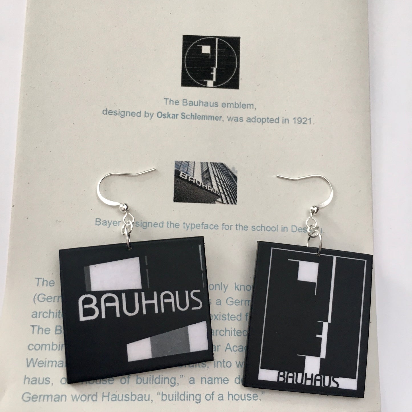Sustainable, asymmetrical art earrings inspired by the Bauhaus emblem, designed by Oskar Schlemmer.