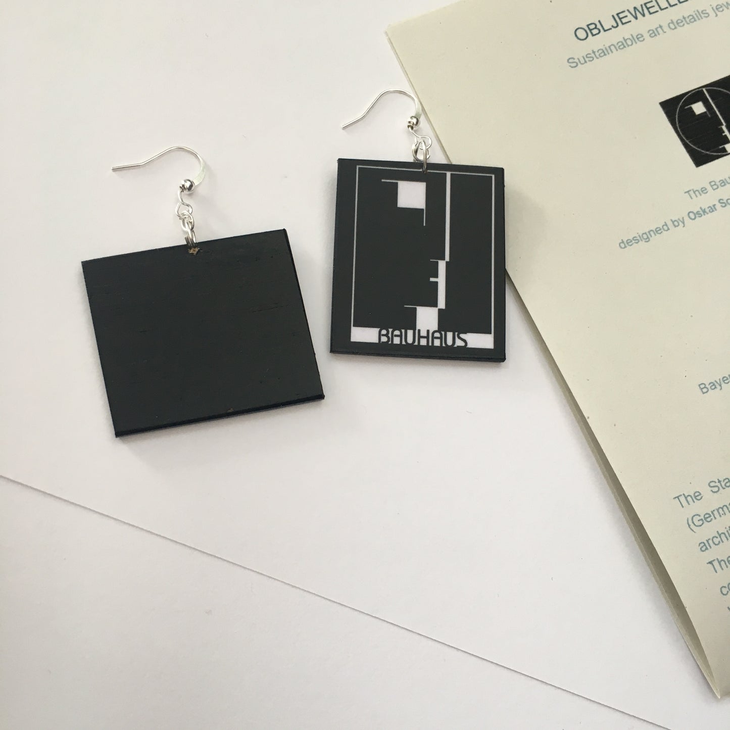 Sustainable, asymmetrical art earrings inspired by the Bauhaus emblem, designed by Oskar Schlemmer.
